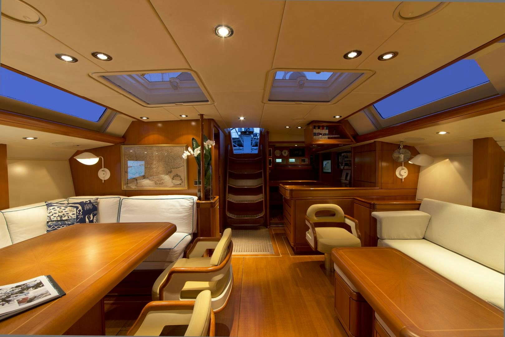 a room with a couch and a table and chairs aboard METOLIUS Yacht for Sale