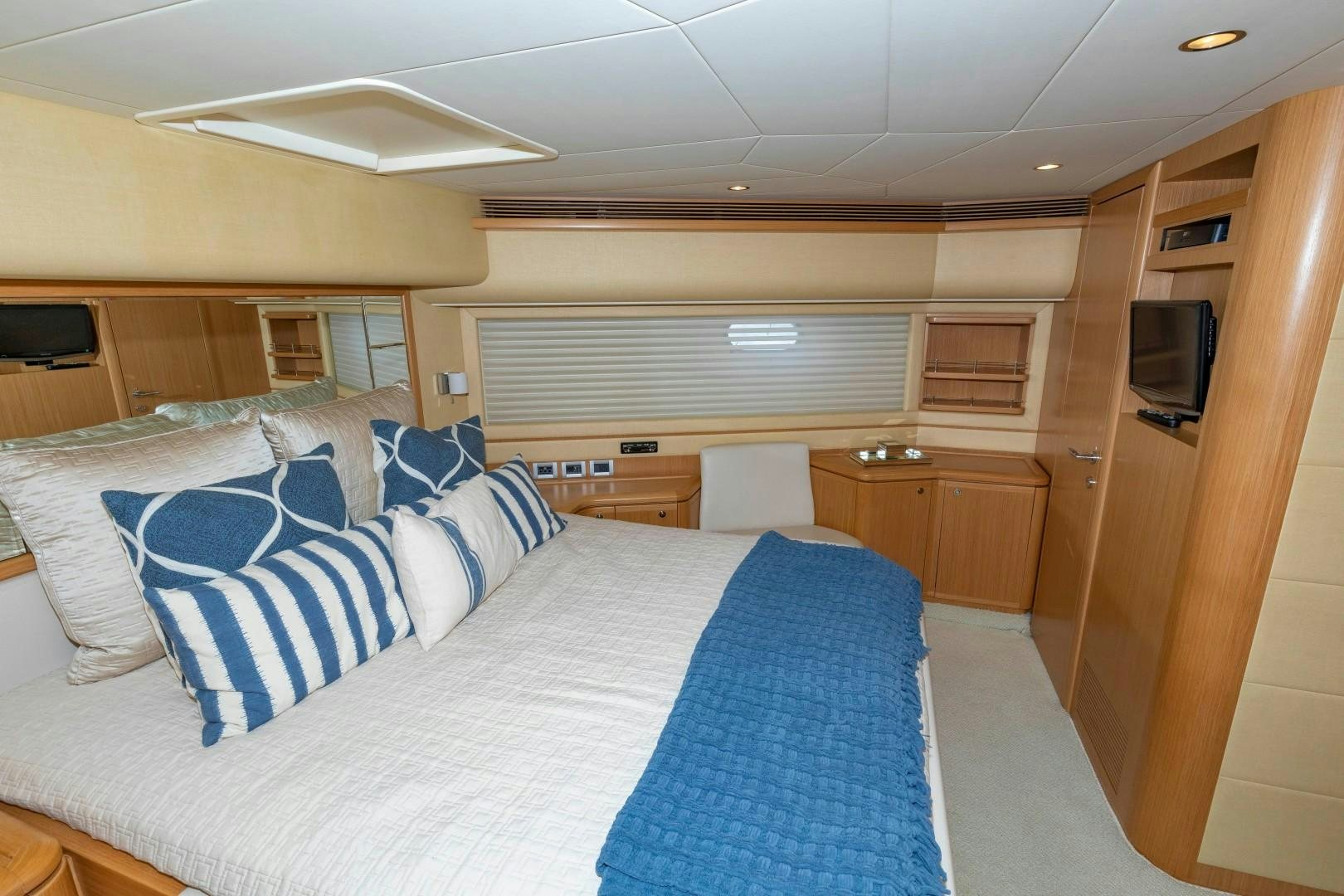 a bedroom with a bed and a television aboard MI RX Yacht for Sale