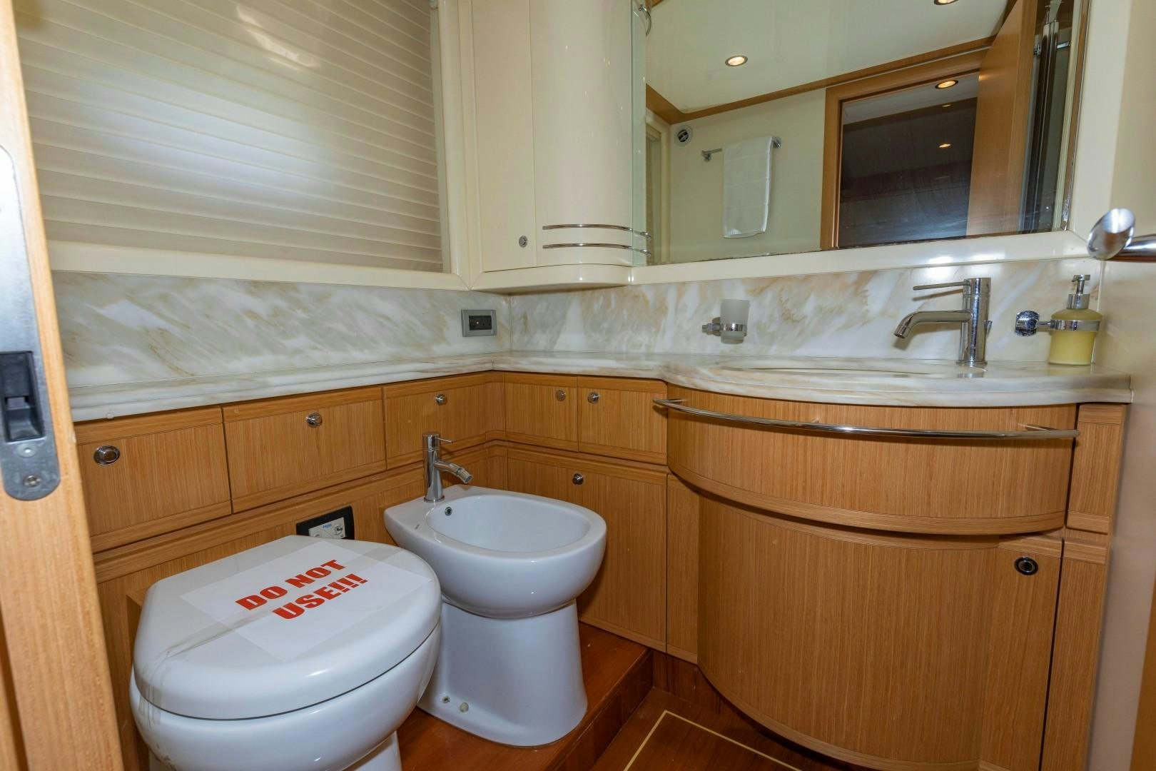 a bathroom with a toilet and sink aboard MI RX Yacht for Sale