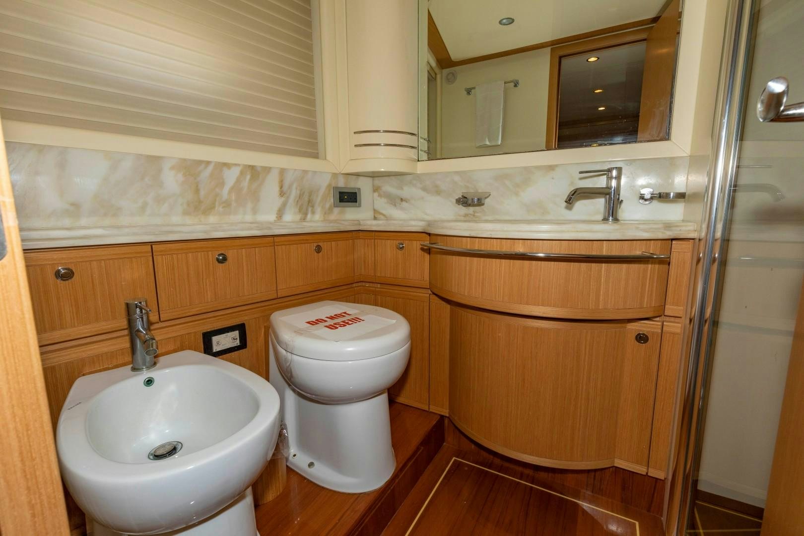 a bathroom with a toilet and sink aboard MI RX Yacht for Sale