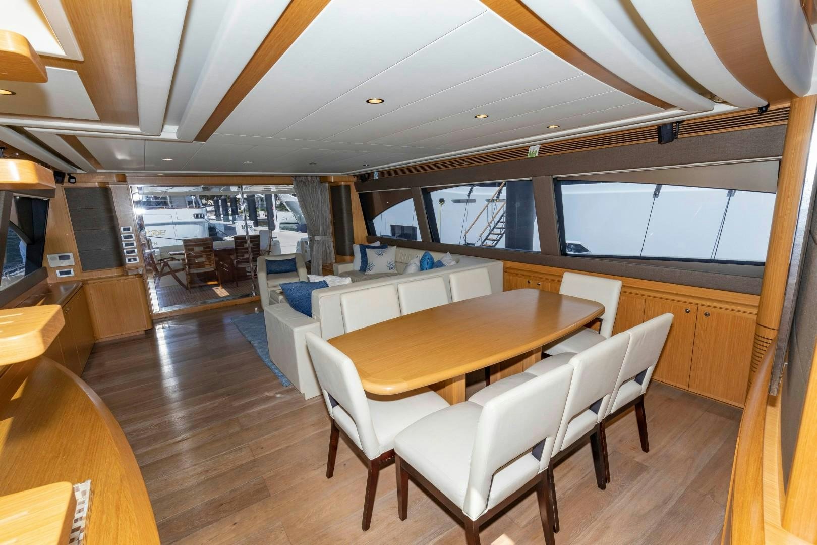 a room with tables and chairs aboard MI RX Yacht for Sale