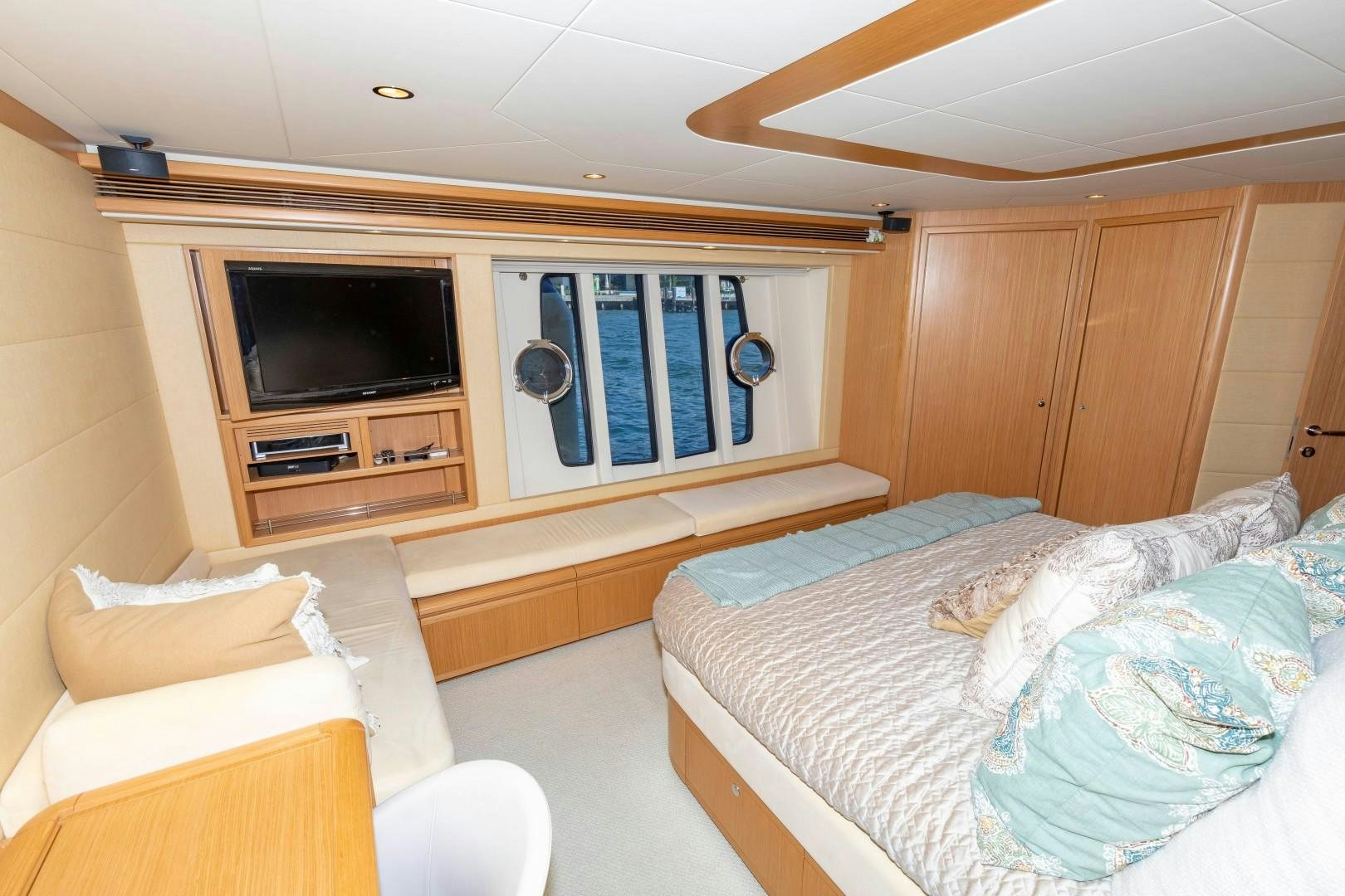 a bedroom with a bed and a television aboard MI RX Yacht for Sale