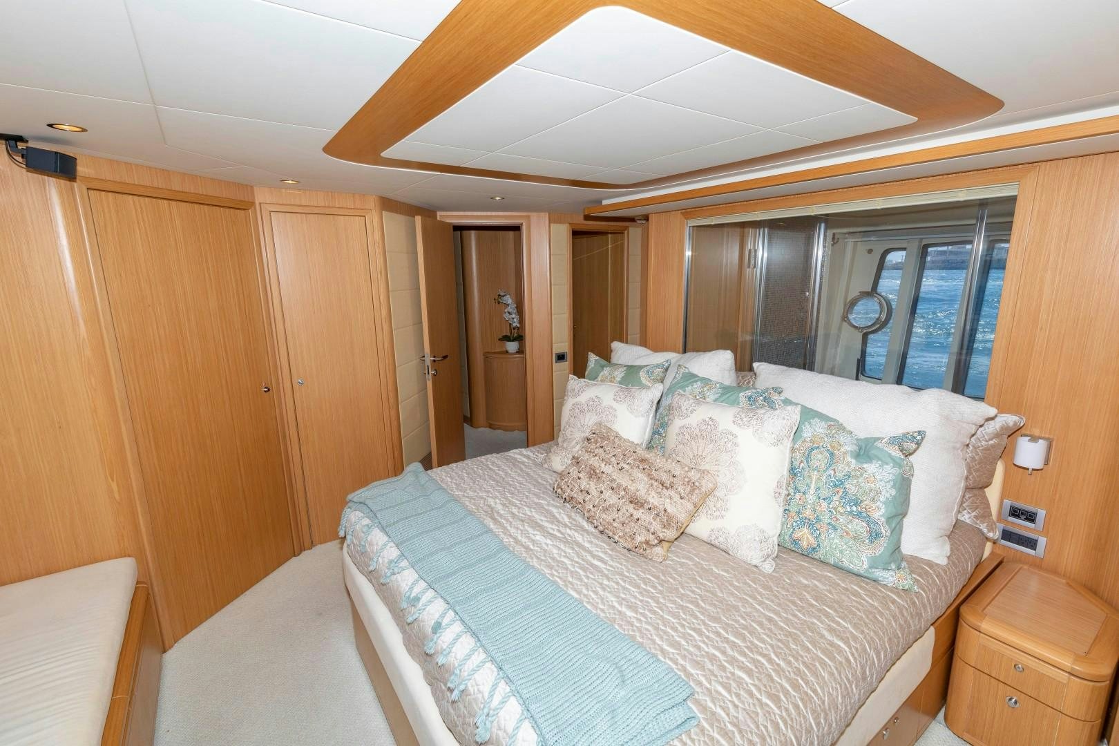 a bed with pillows aboard MI RX Yacht for Sale