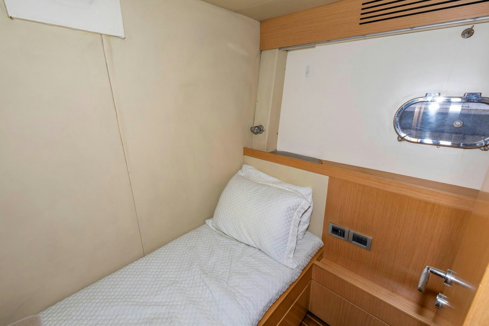 a bed with a white pillow aboard MI RX Yacht for Sale