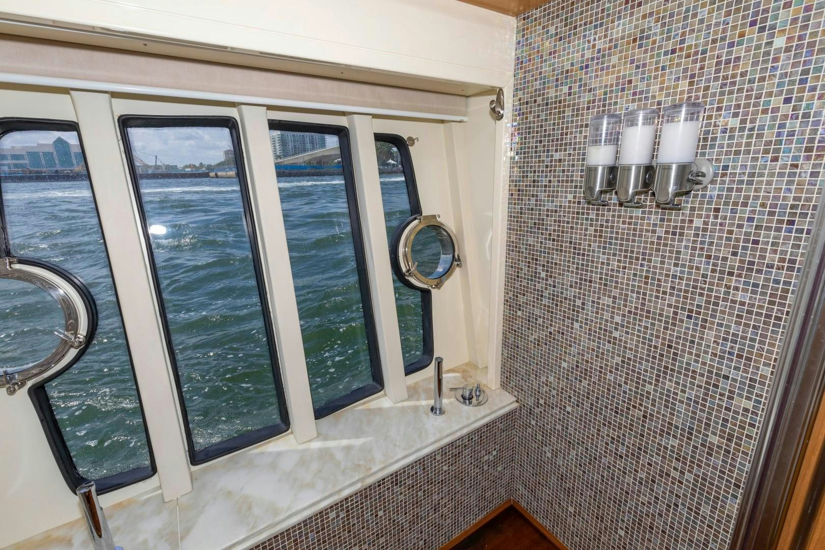 a bathroom with a glass shower aboard MI RX Yacht for Sale
