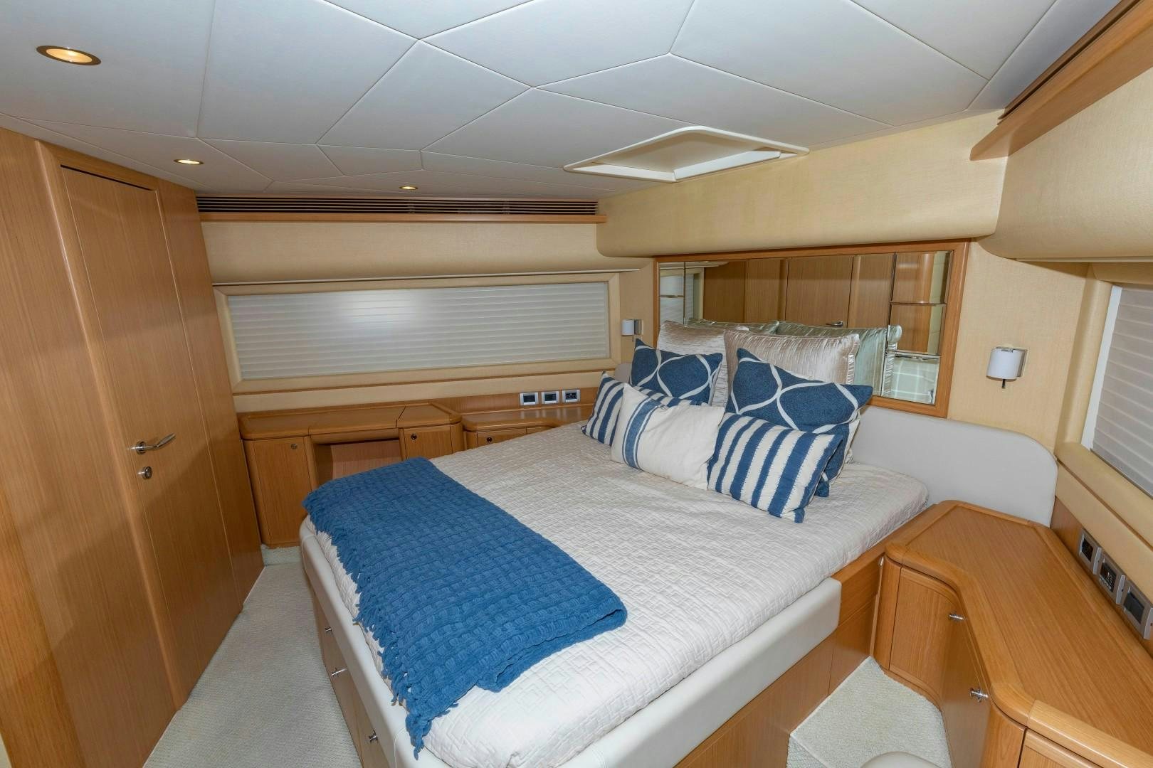 a bedroom with a bed and a desk aboard MI RX Yacht for Sale
