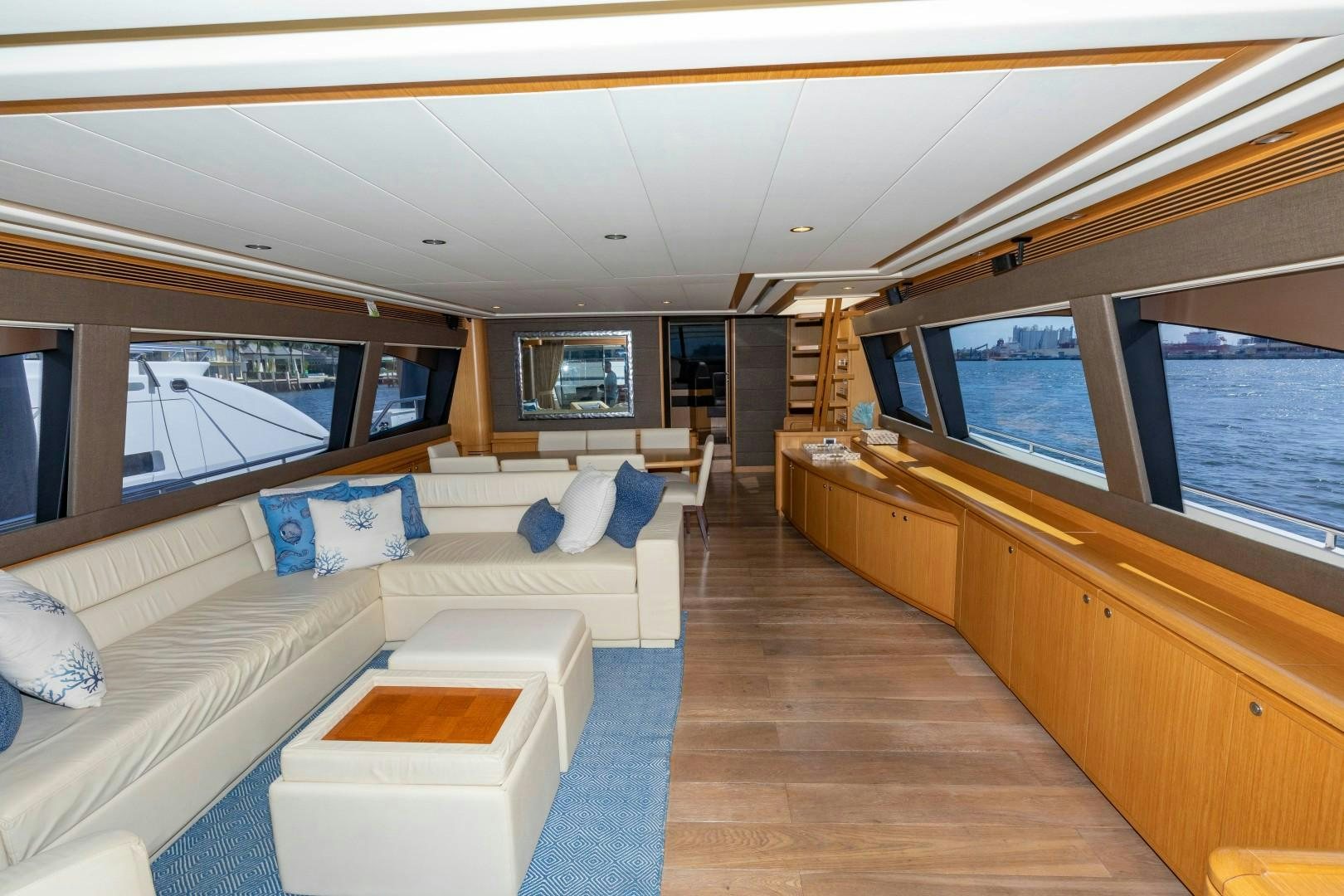 a large living room with a large window aboard MI RX Yacht for Sale