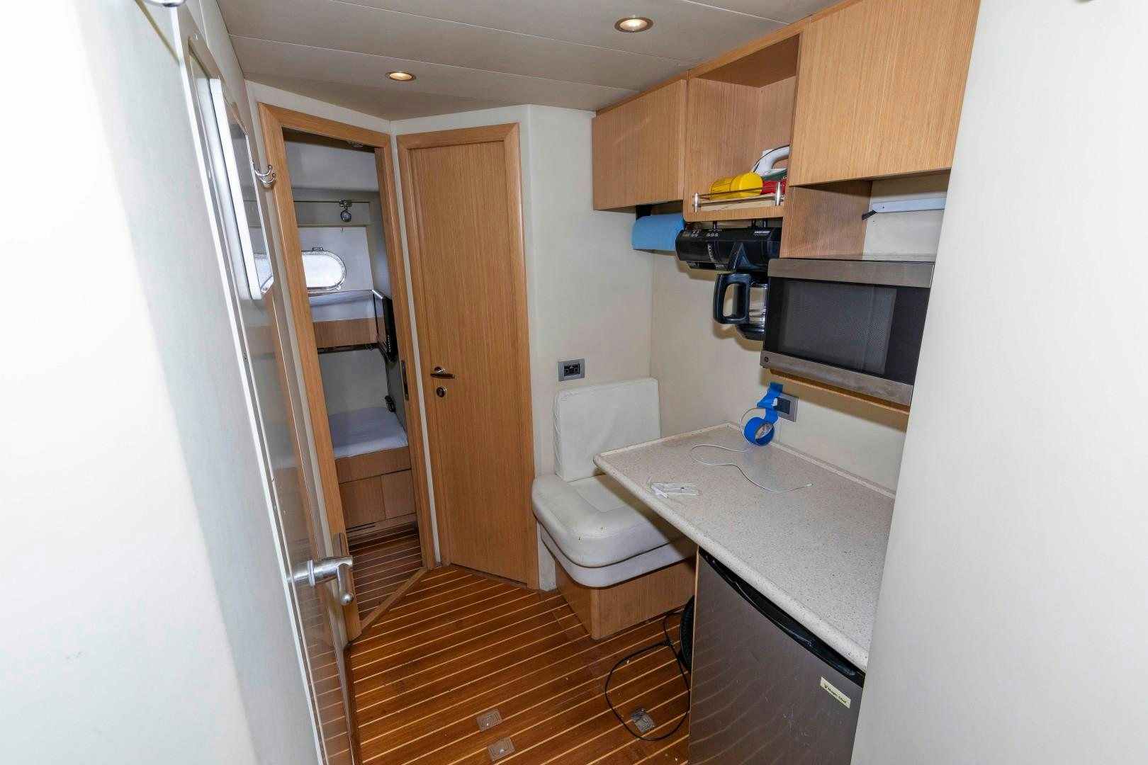 a small bathroom with a wood floor aboard MI RX Yacht for Sale