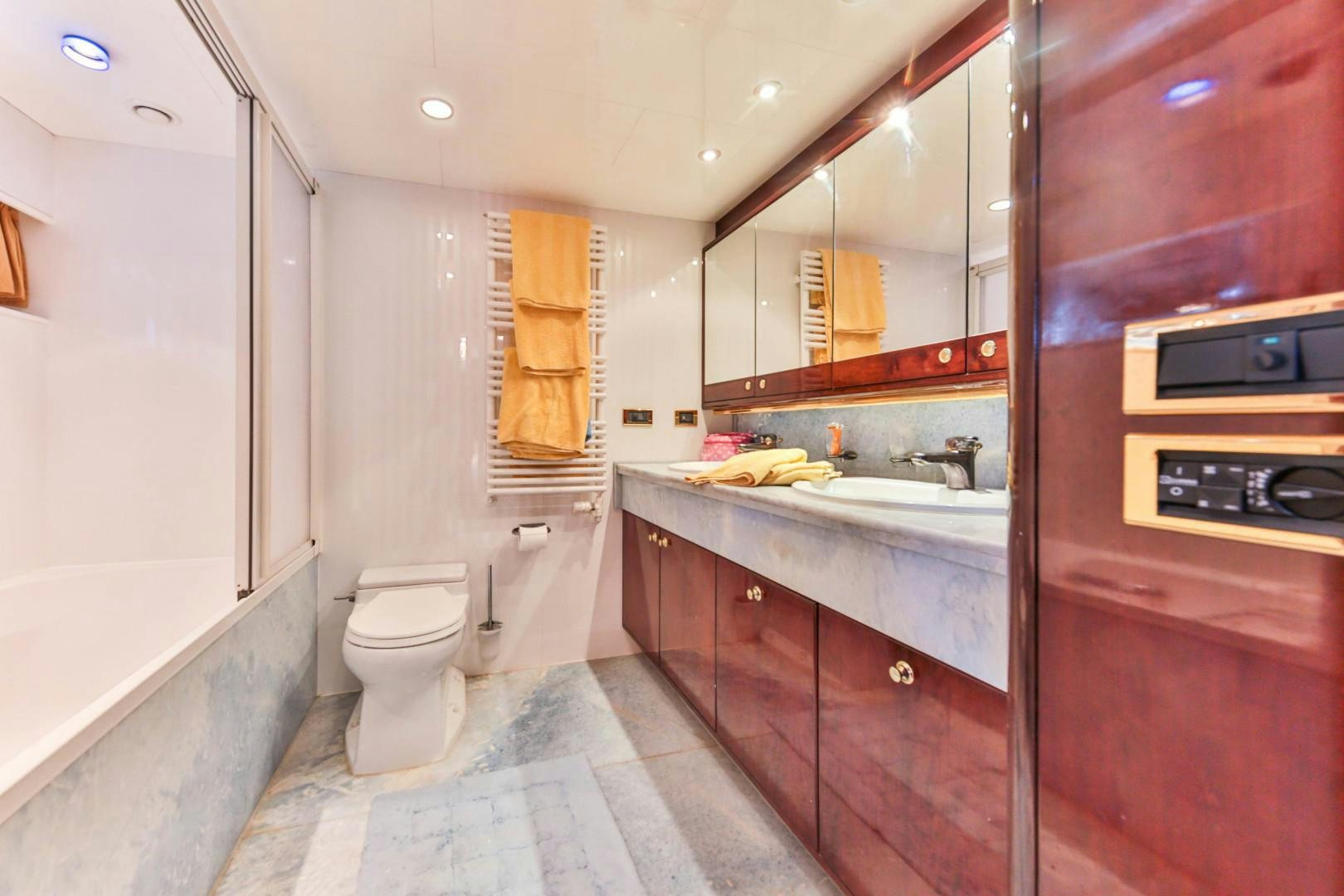 a bathroom with a toilet sink and cabinets aboard HAPPY DAZE Yacht for Sale