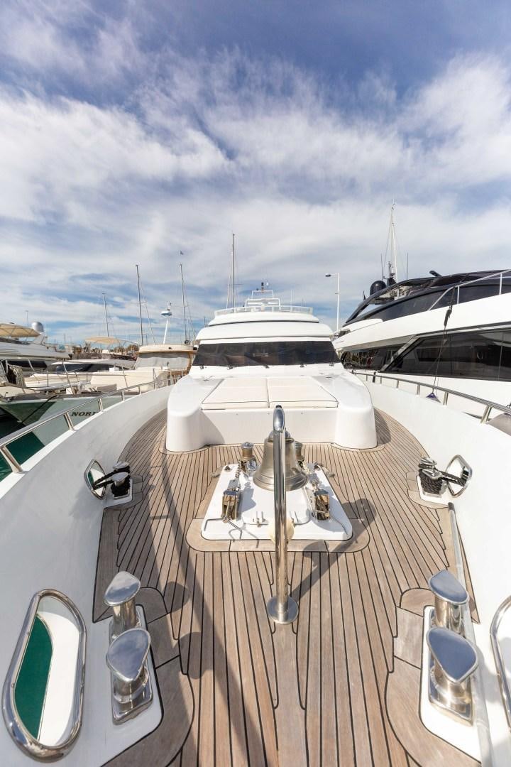 a deck with a table and chairs on it aboard HAPPY DAZE Yacht for Sale