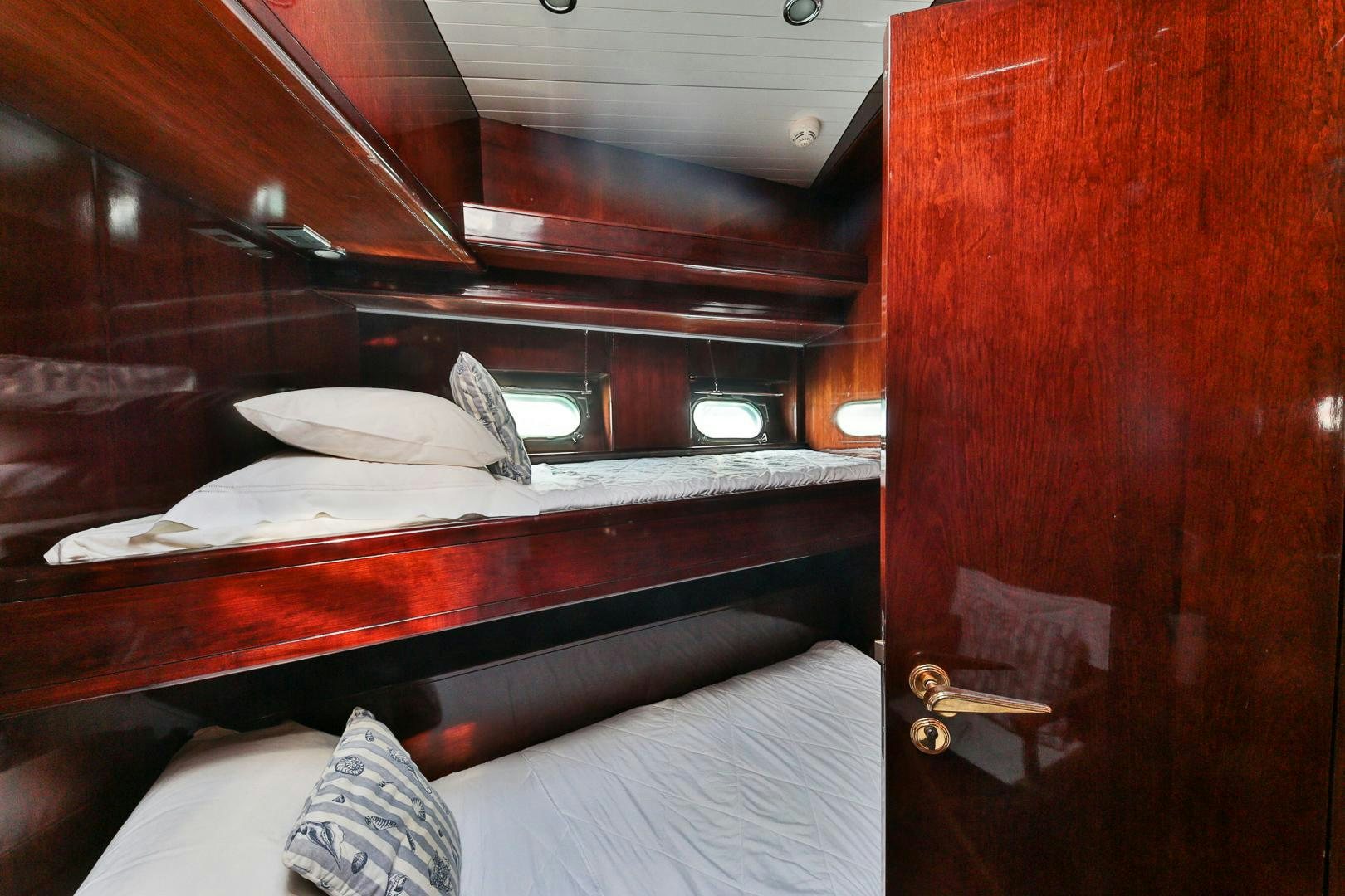 a bed with a wooden headboard aboard HAPPY DAZE Yacht for Sale