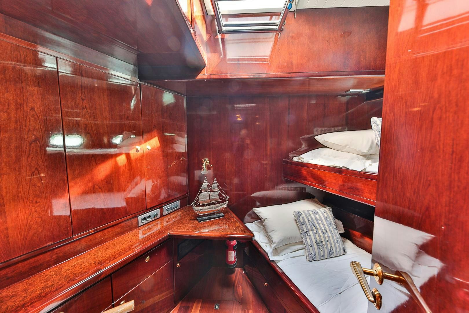 a room with a bed and a table aboard HAPPY DAZE Yacht for Sale