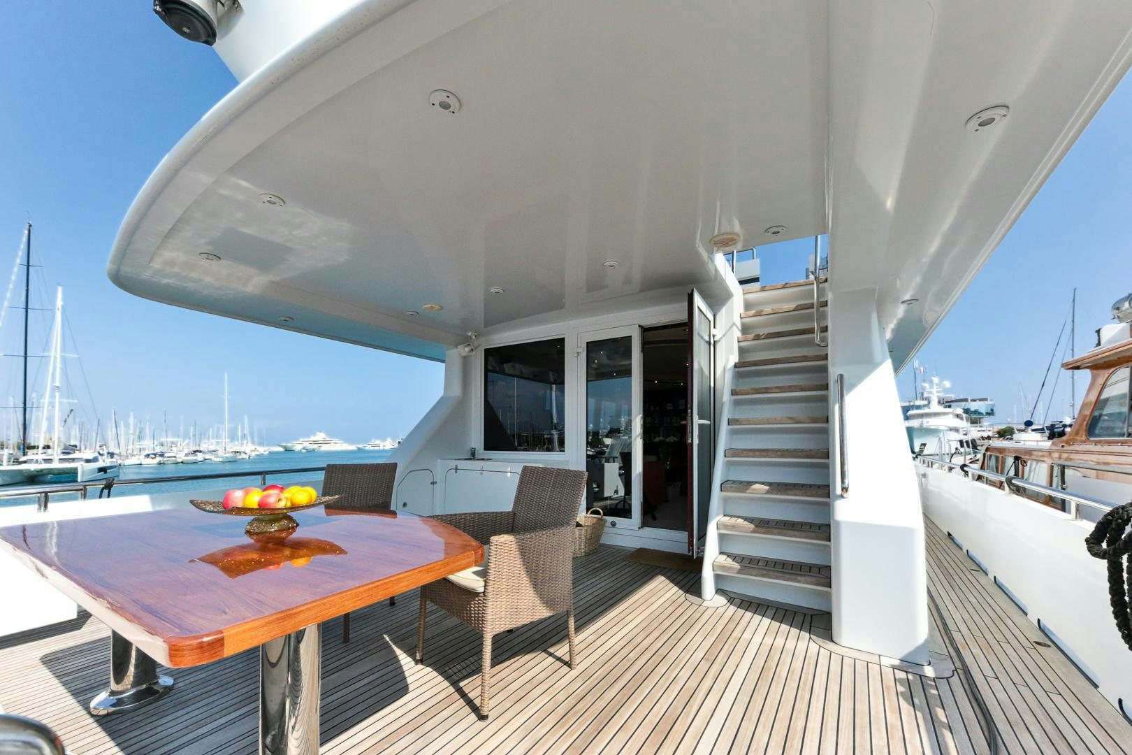 a table and chairs on a deck aboard HAPPY DAZE Yacht for Sale