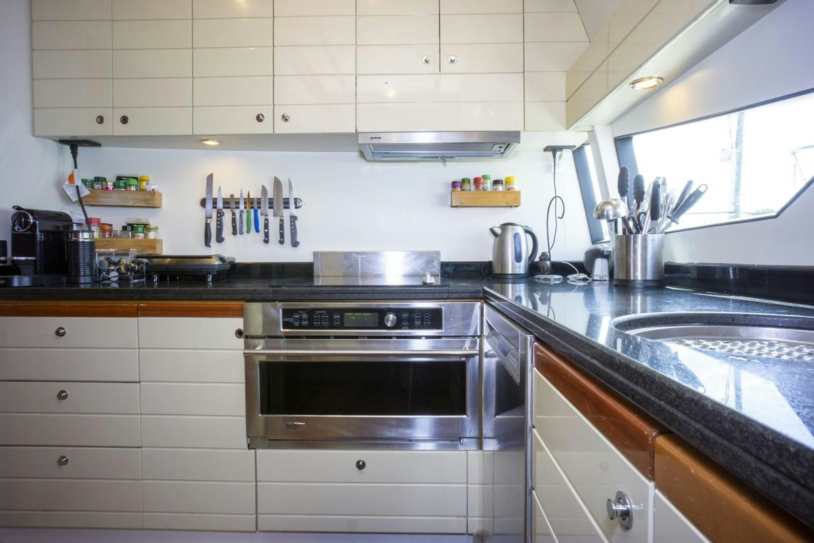 a kitchen with stainless steel appliances aboard NO NAME Yacht for Sale