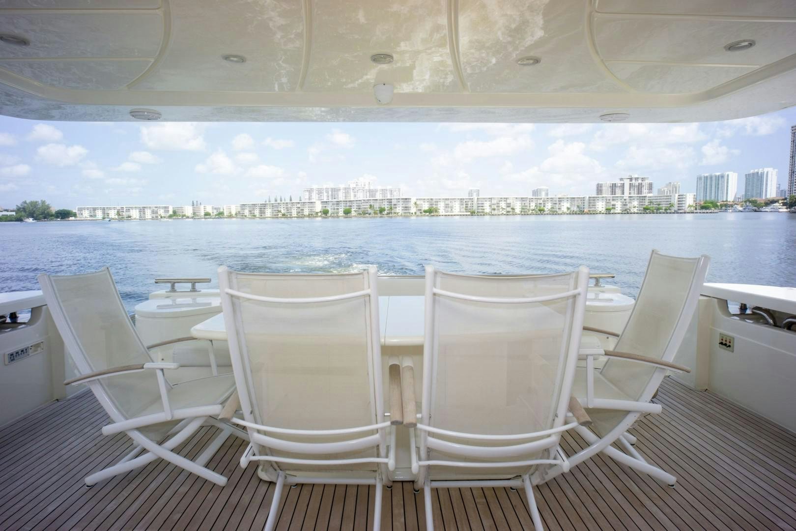 a group of chairs on a deck overlooking a city aboard NO NAME Yacht for Sale