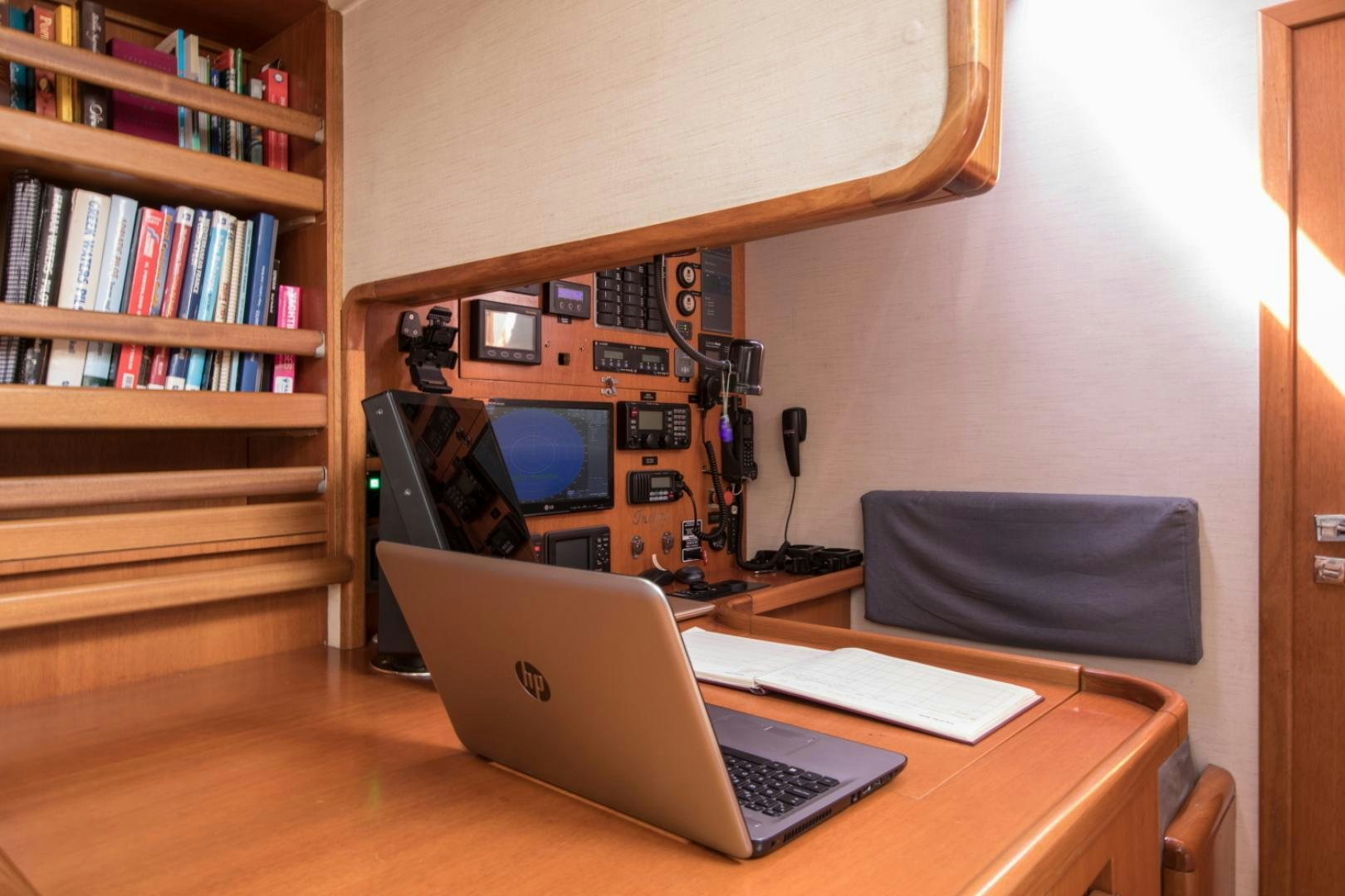 a laptop on a desk aboard INDIGO Yacht for Sale