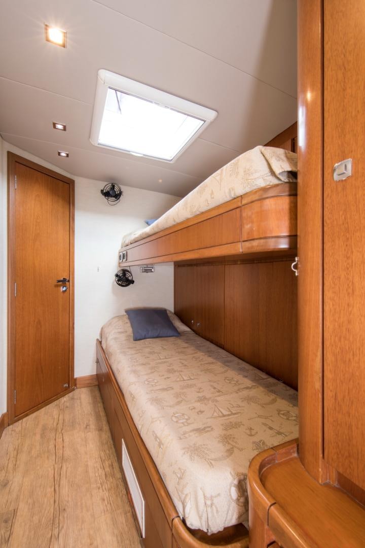 a bedroom with a wood bunk bed aboard INDIGO Yacht for Sale