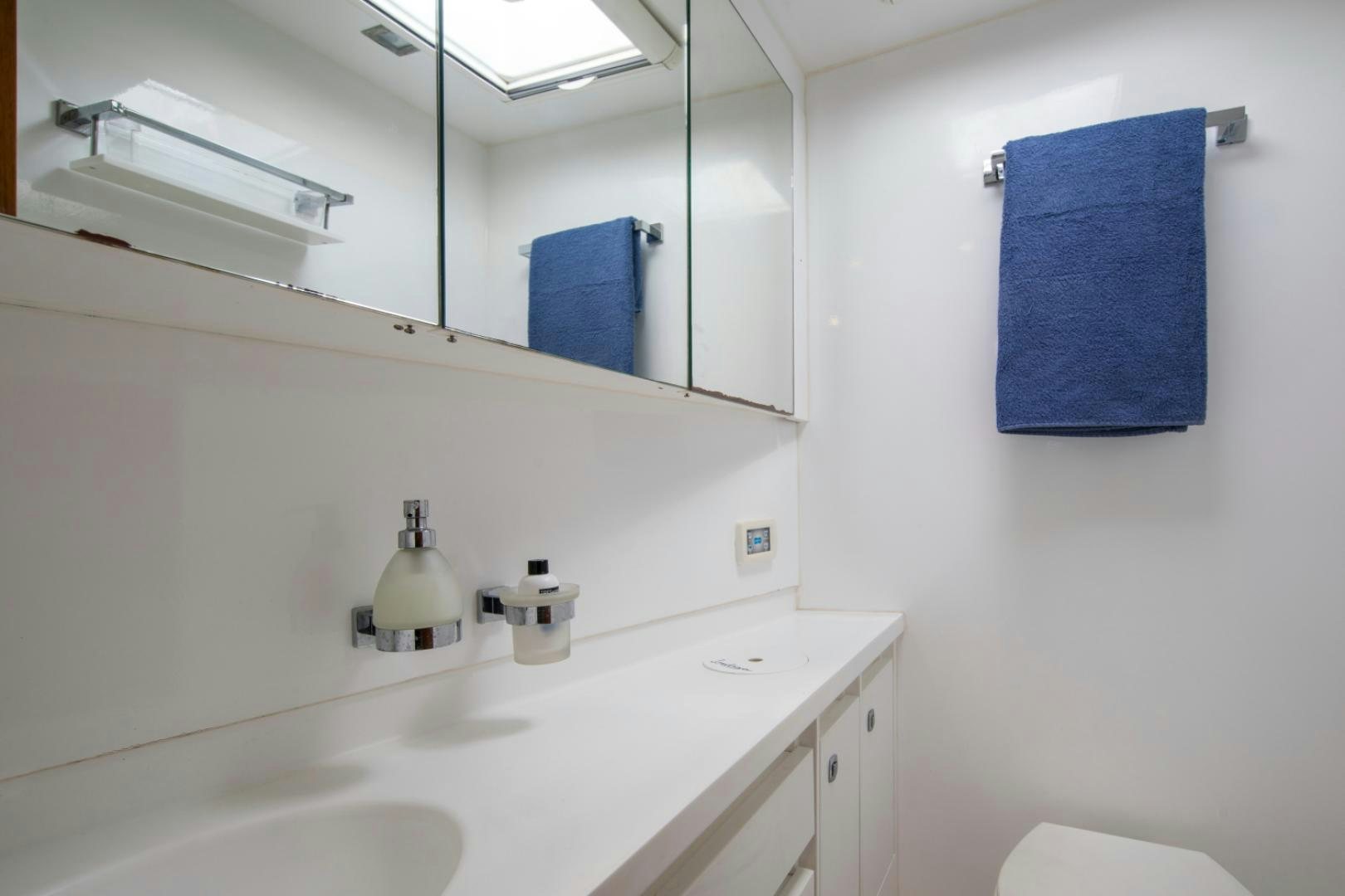 a bathroom with a sink and mirror aboard INDIGO Yacht for Sale