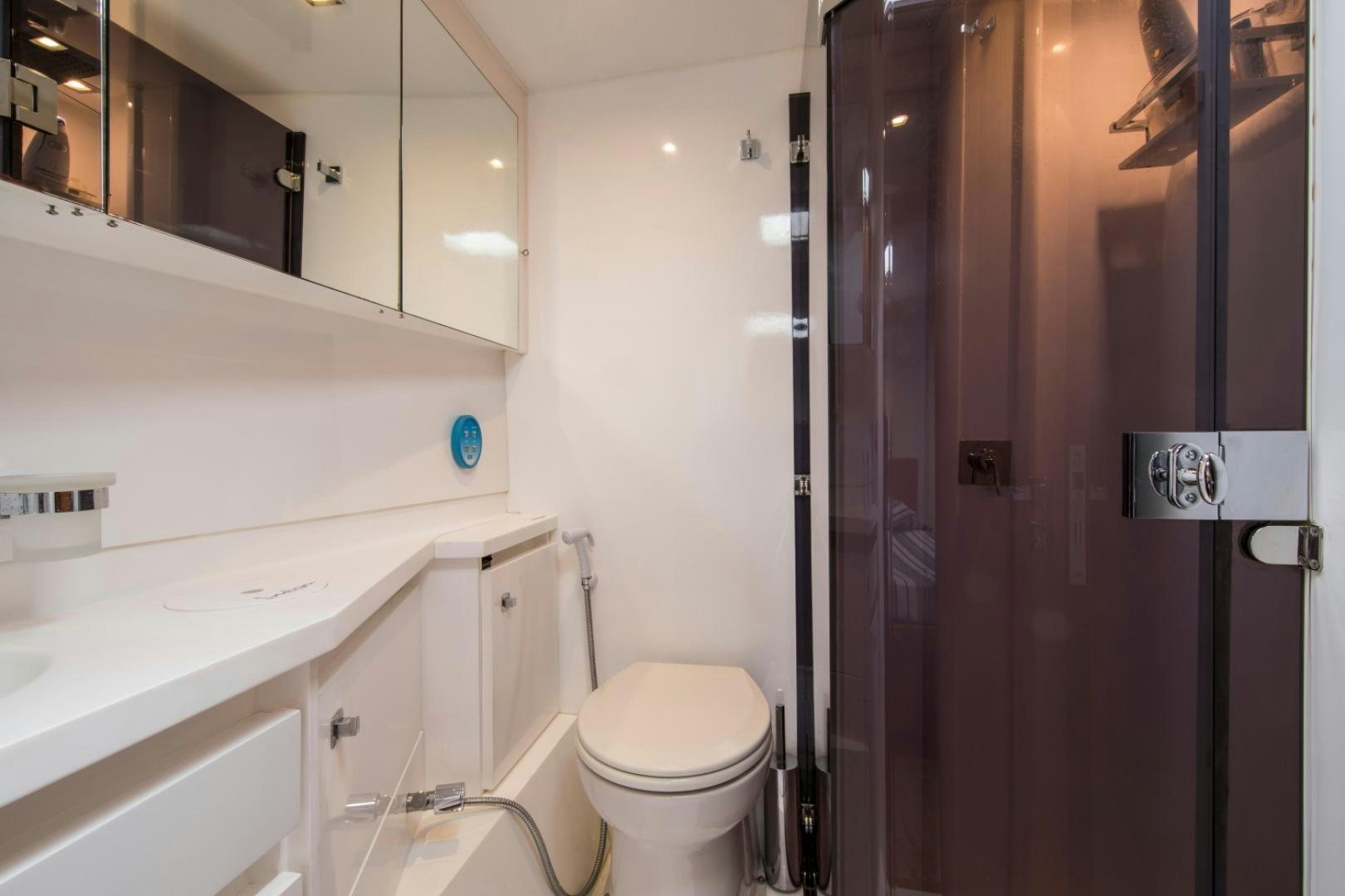 a bathroom with a toilet and sink aboard INDIGO Yacht for Sale