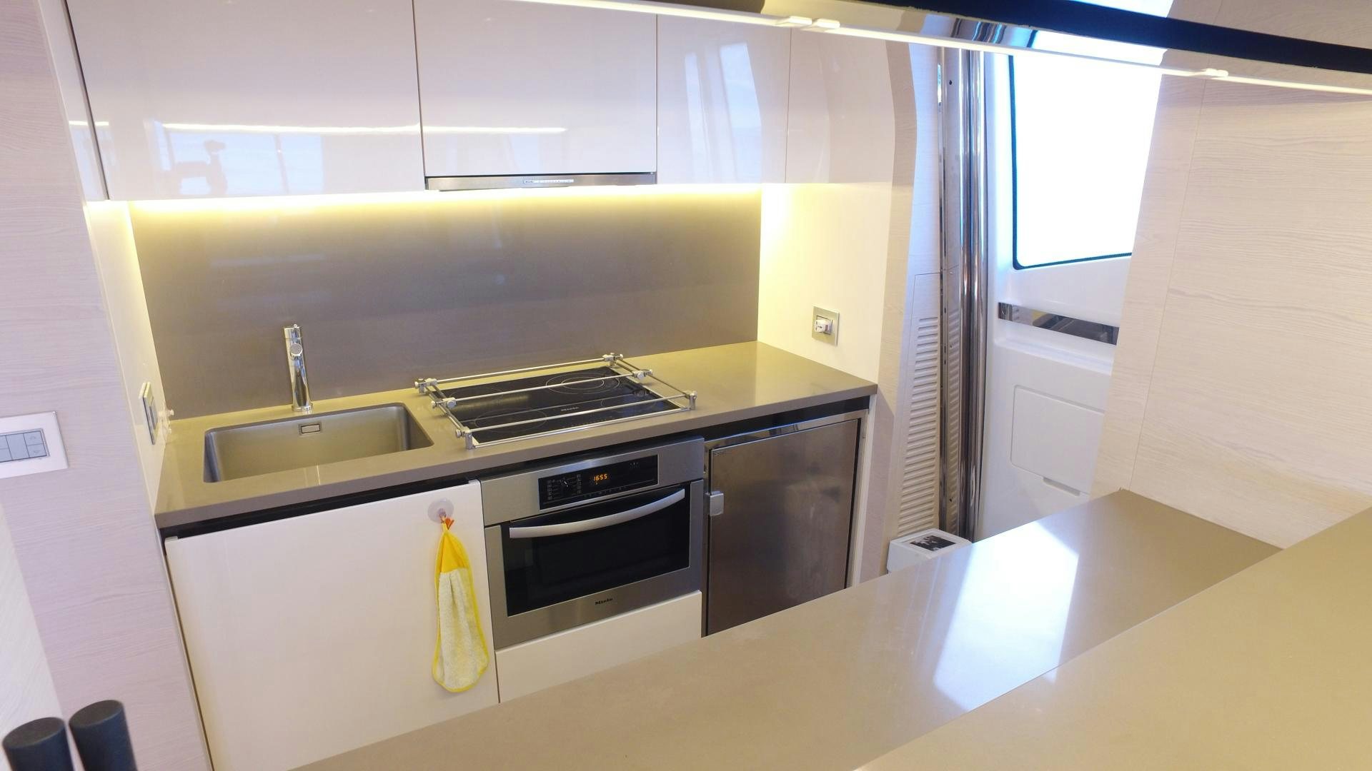 a kitchen with a stove and sink aboard OKS Yacht for Sale