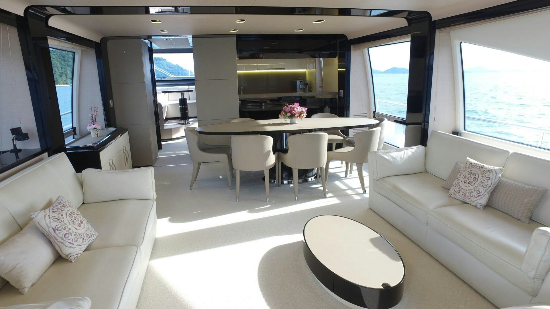 a living room with a table and couches aboard OKS Yacht for Sale