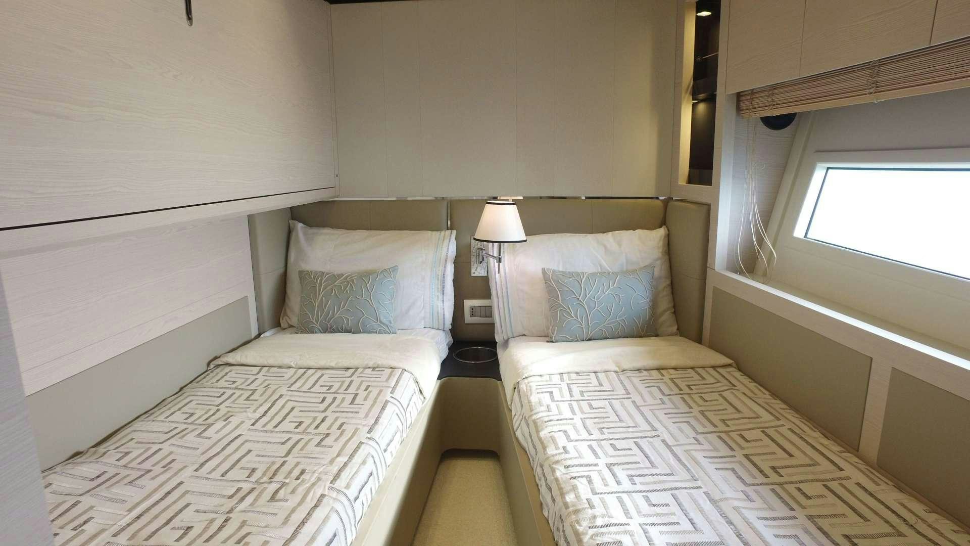 a couple of beds in a room aboard OKS Yacht for Sale