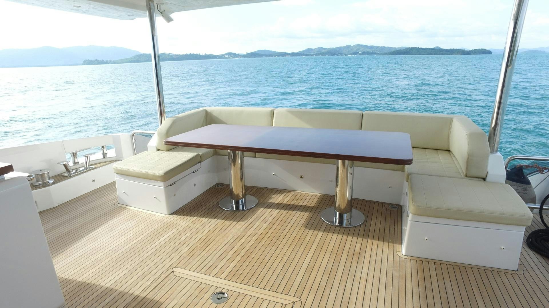 a white bed on a boat aboard OKS Yacht for Sale