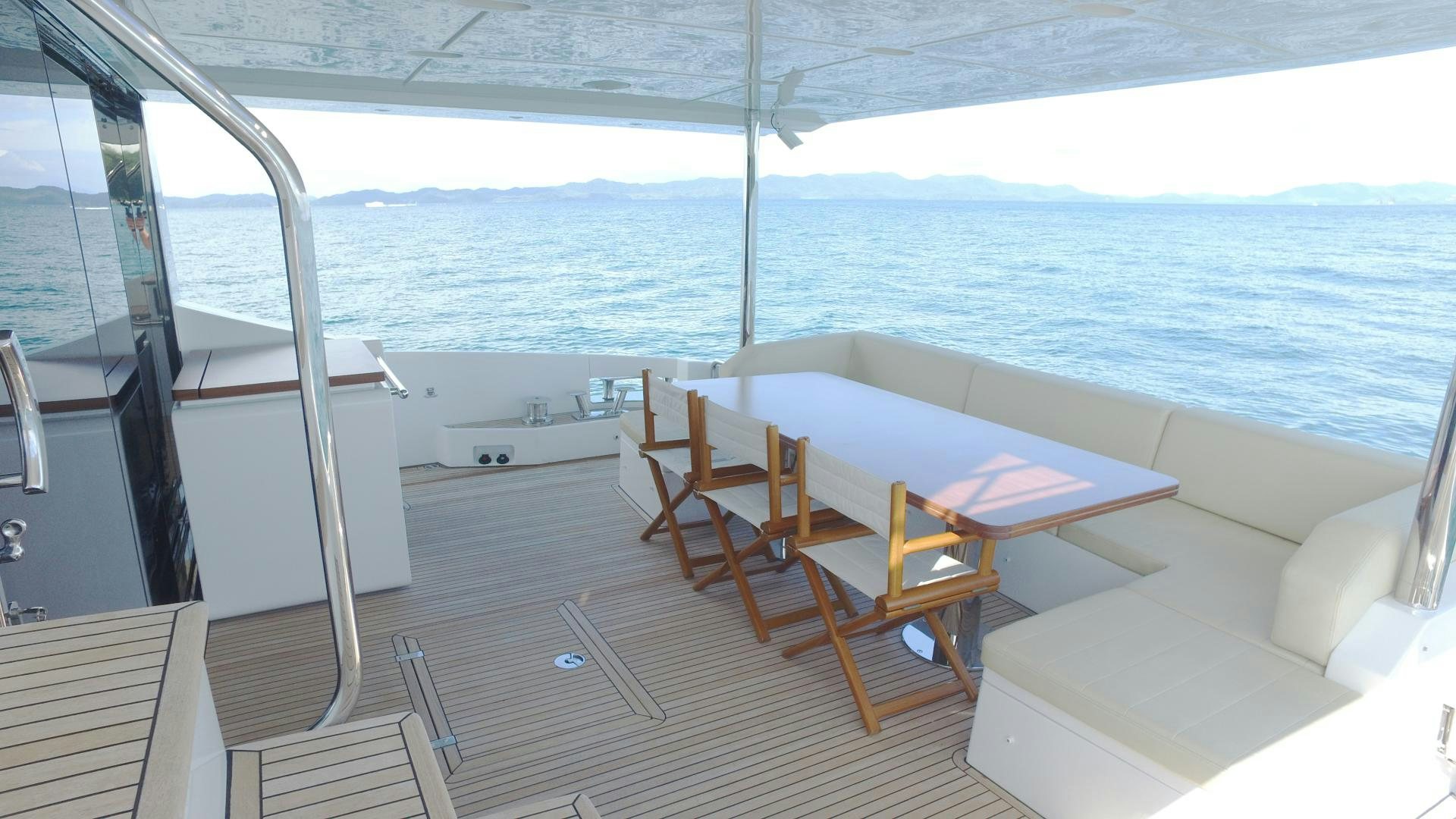 a room with a table and chairs aboard OKS Yacht for Sale