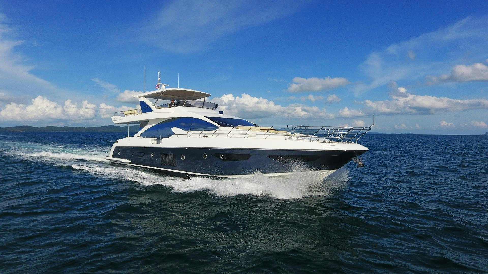 a white boat on the water aboard OKS Yacht for Sale