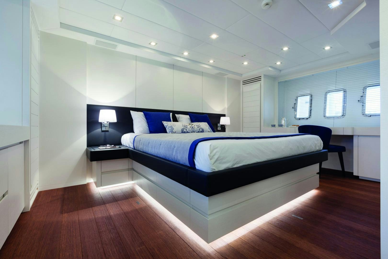 a bedroom with a bed and a desk aboard MY TOY Yacht for Sale