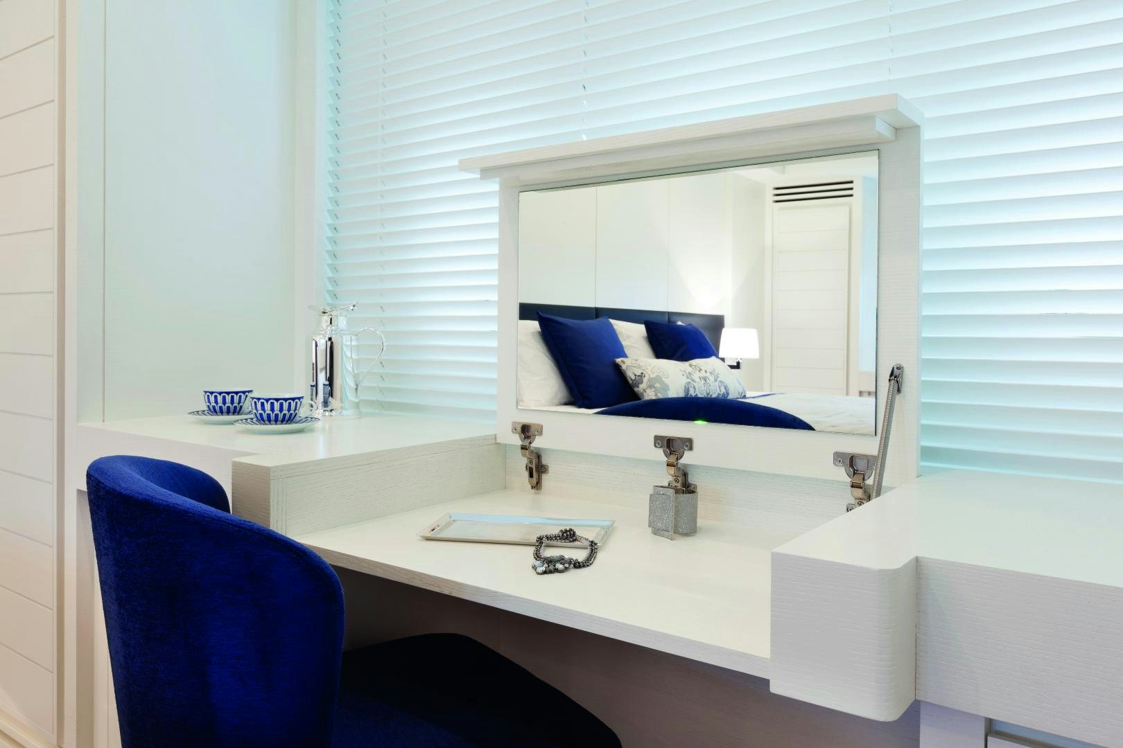 a white desk with a blue chair aboard MY TOY Yacht for Sale