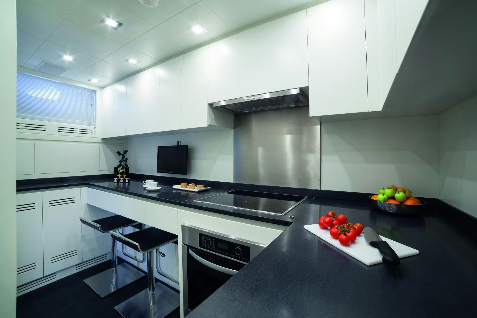 a kitchen with white cabinets aboard MY TOY Yacht for Sale