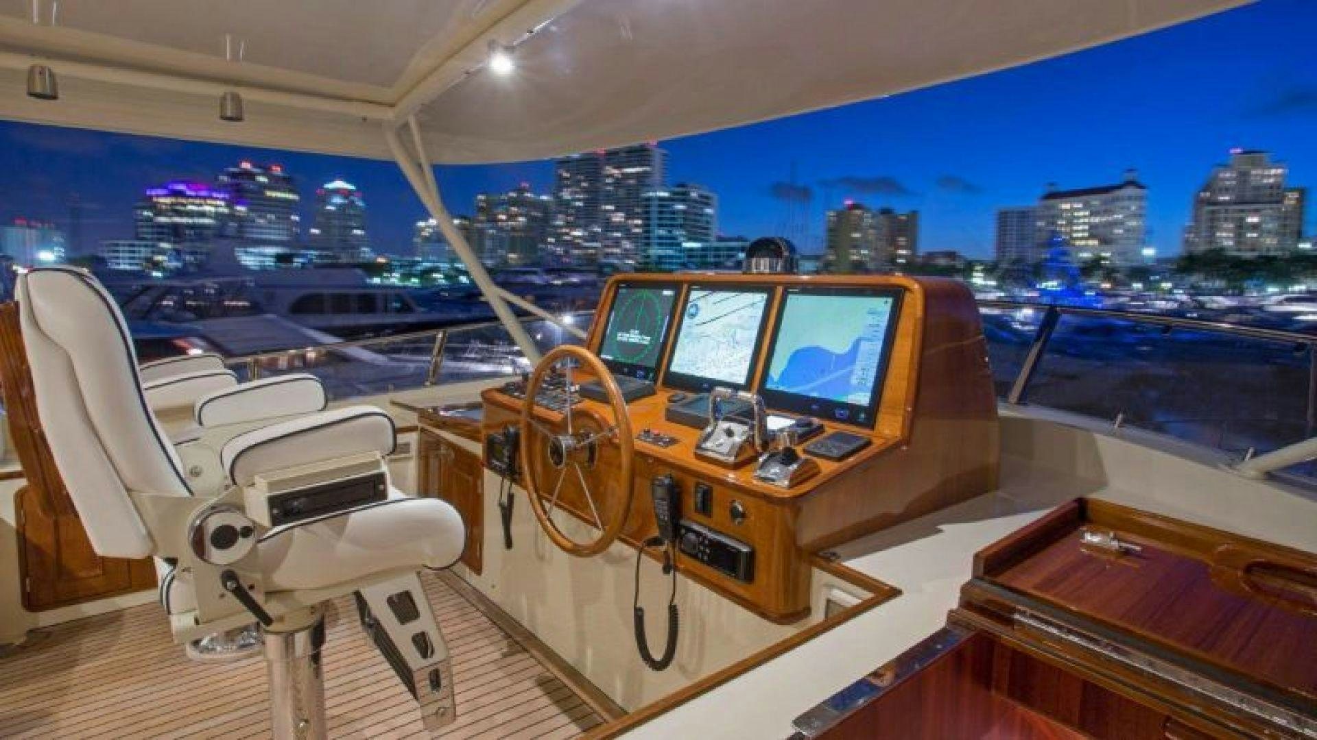 a boat with a desk and computer aboard OCEAN 76 Yacht for Sale