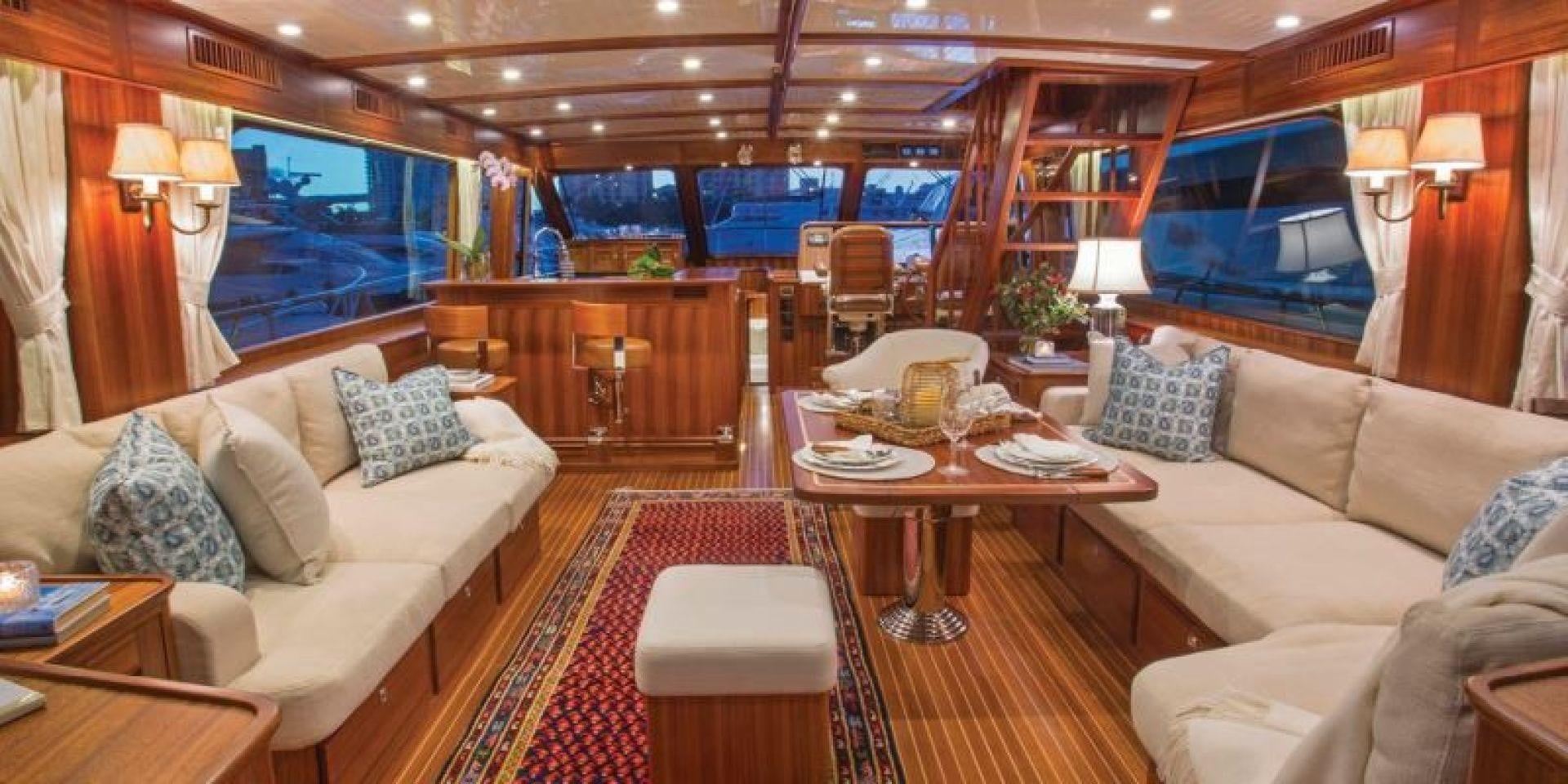 a living room with a couch and a table aboard OCEAN 76 Yacht for Sale