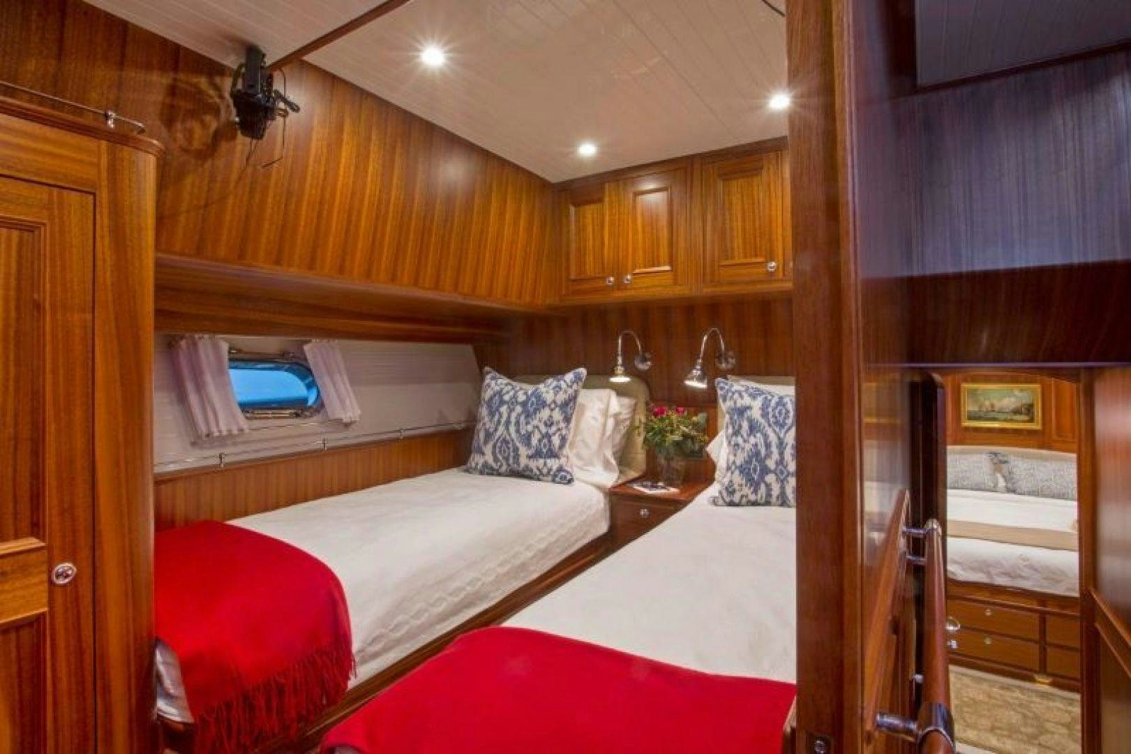 a room with a bed and a desk aboard OCEAN 76 Yacht for Sale