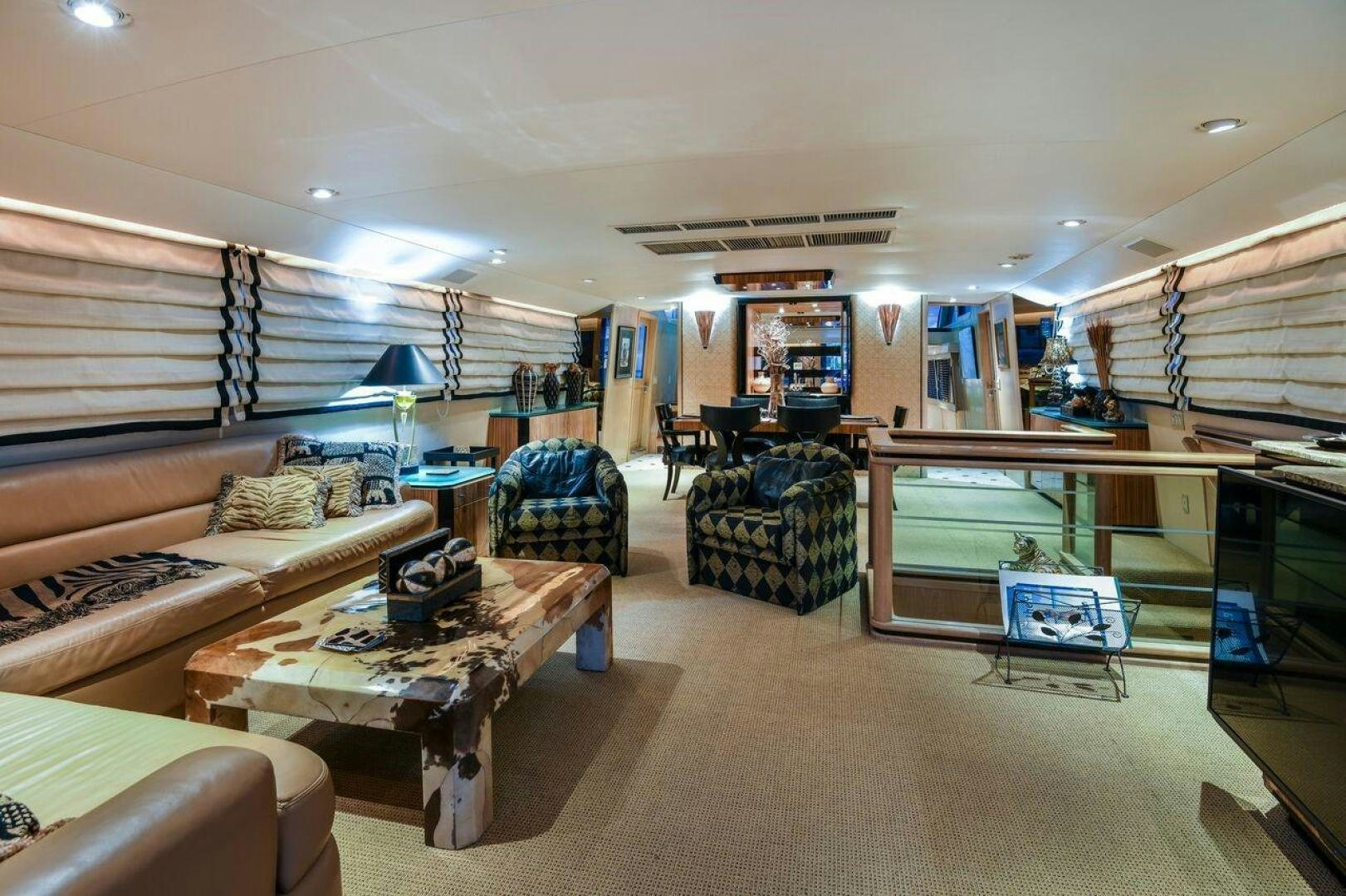 a living room with a couch and a table aboard PRIMETIME III Yacht for Sale