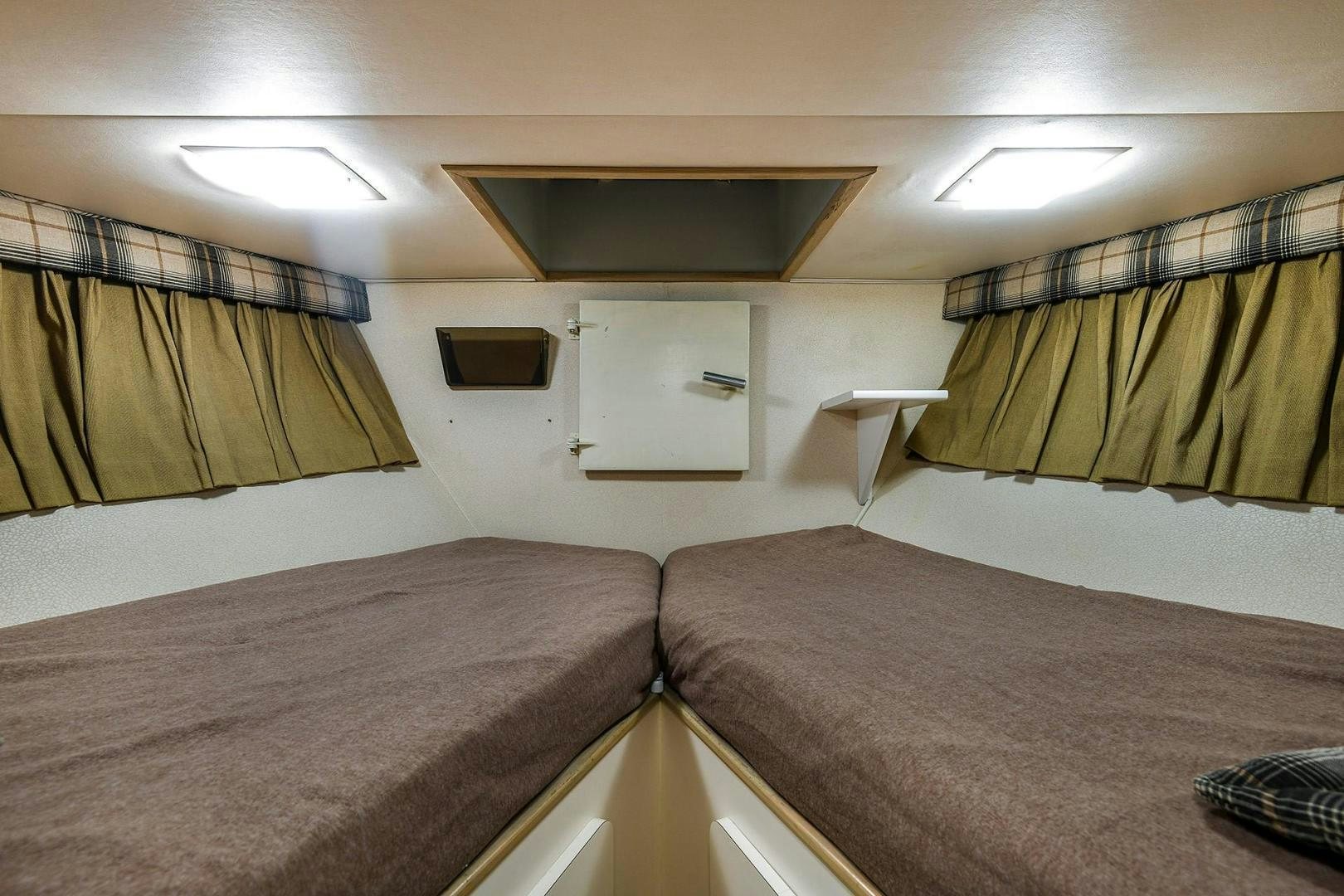 a room with two beds aboard PRIMETIME III Yacht for Sale