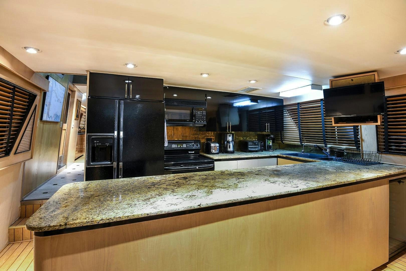 a kitchen with a large island aboard PRIMETIME III Yacht for Sale