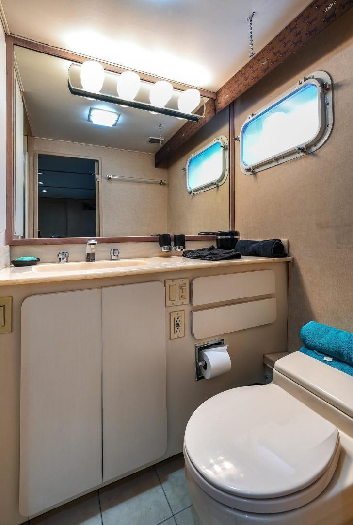 a bathroom with a toilet and a sink aboard PRIMETIME III Yacht for Sale