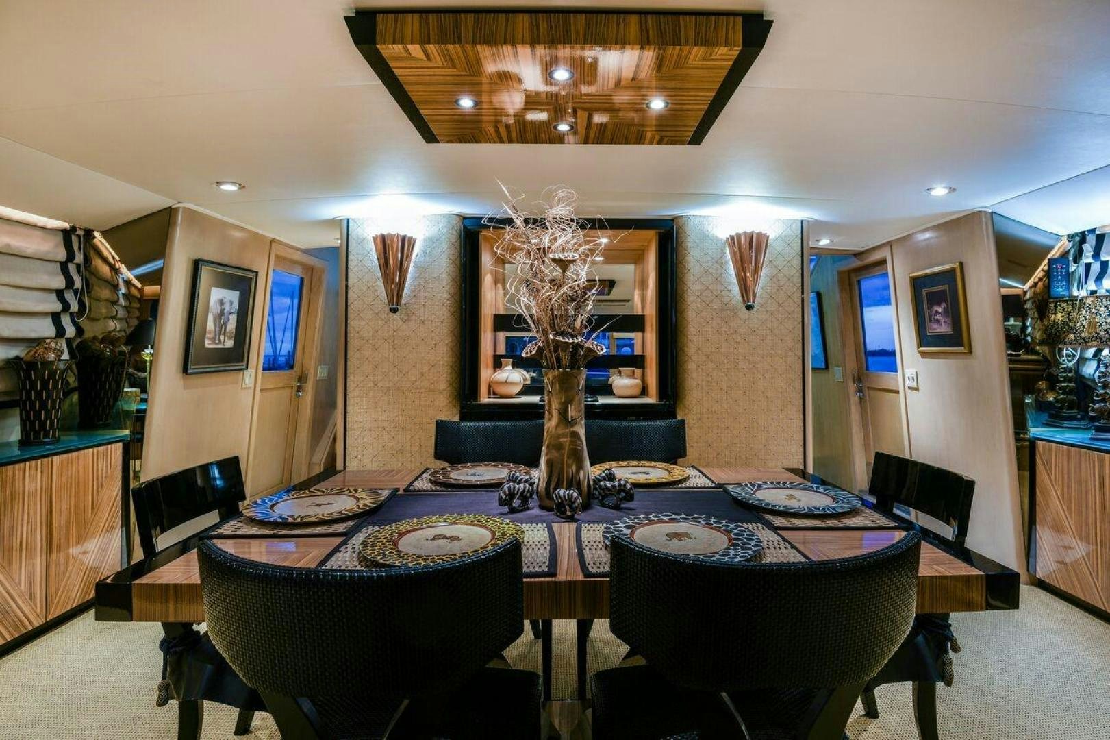 a dining room with a table and chairs aboard PRIMETIME III Yacht for Sale