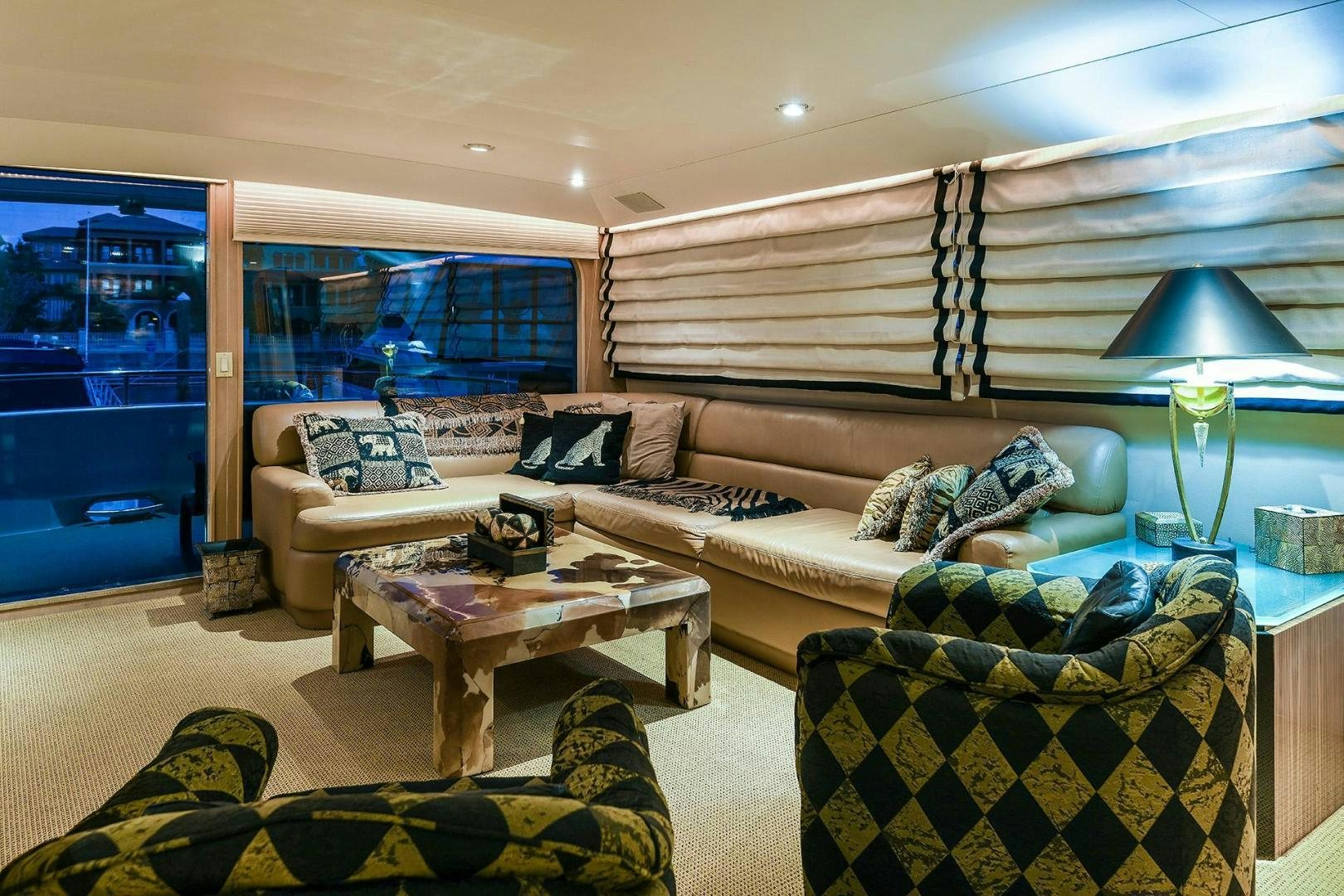 a living room with a couch and a table aboard PRIMETIME III Yacht for Sale