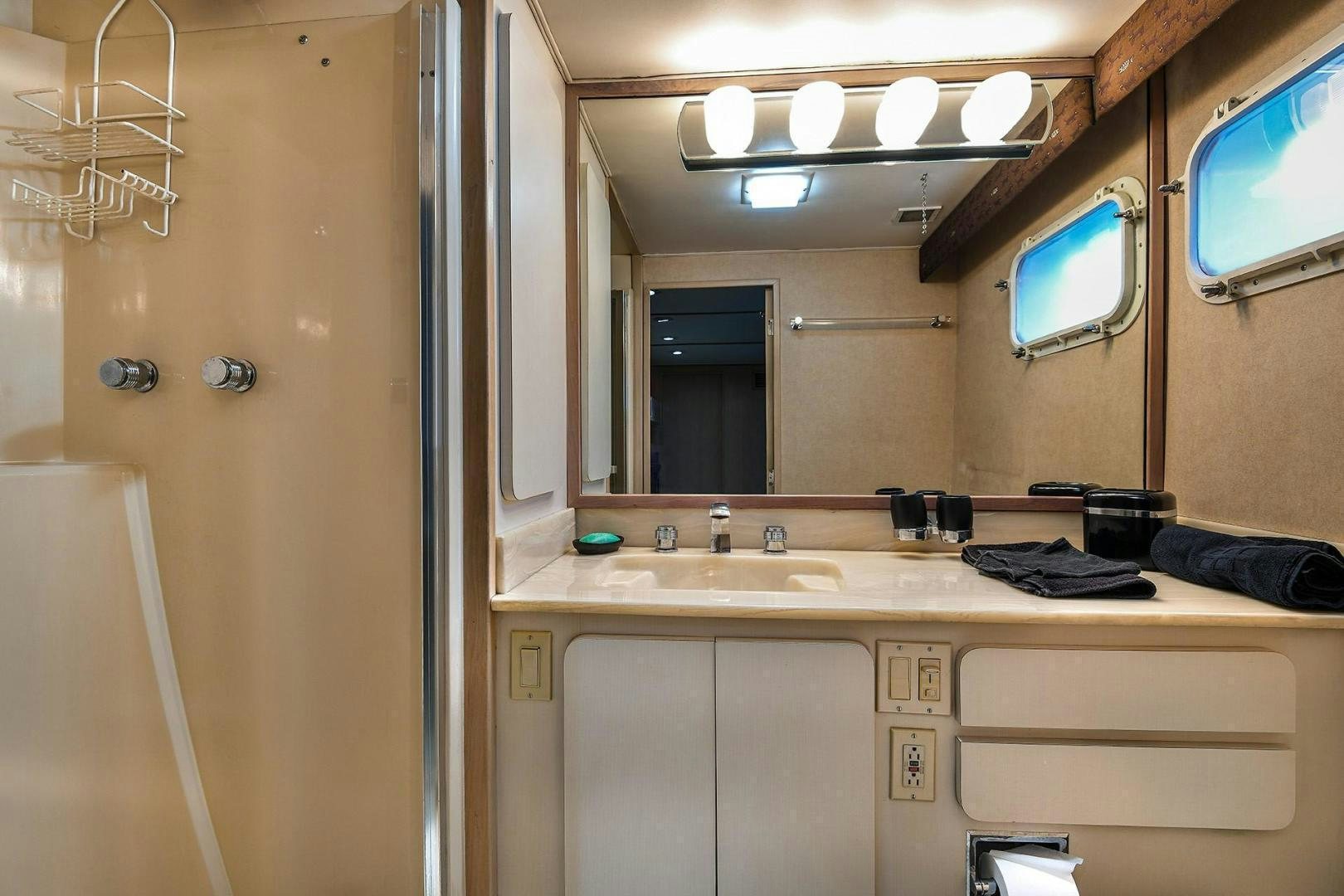 a bathroom with a sink and mirrors aboard PRIMETIME III Yacht for Sale