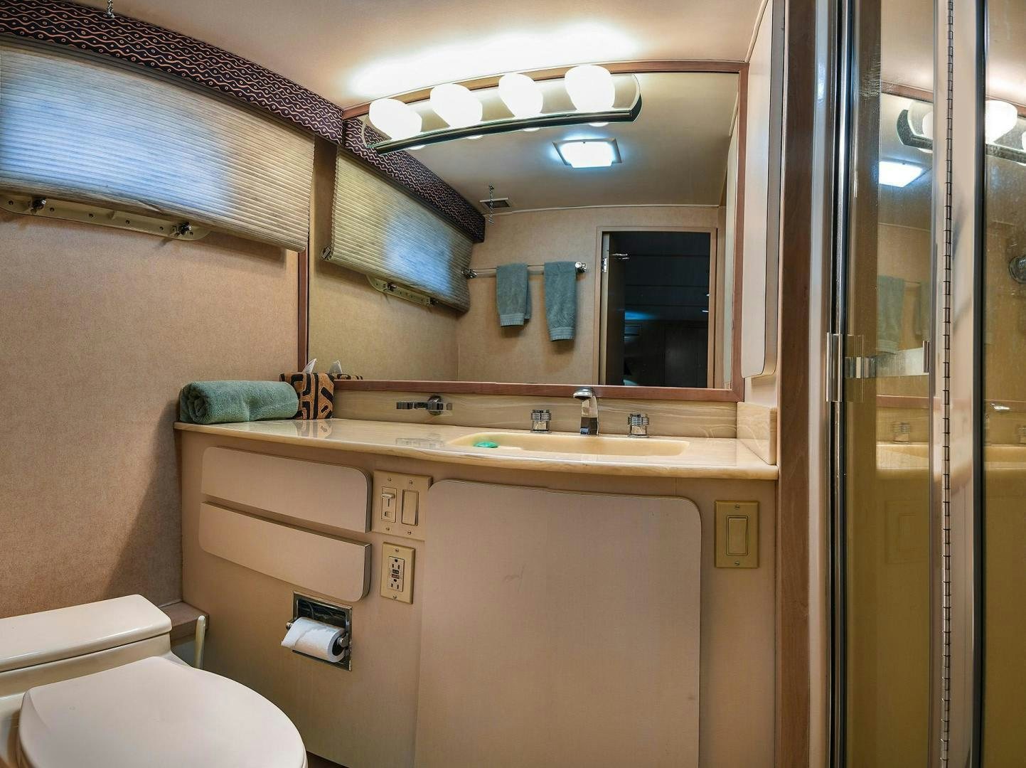 a bathroom with a sink and a toilet aboard PRIMETIME III Yacht for Sale