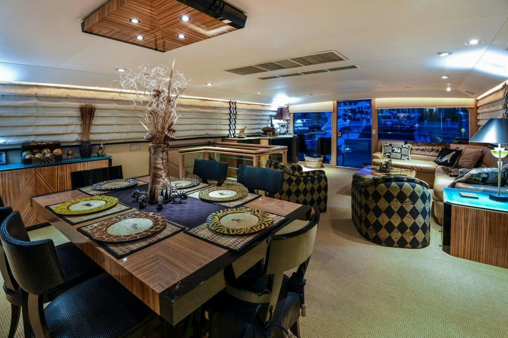a large room with a table and chairs aboard PRIMETIME III Yacht for Sale