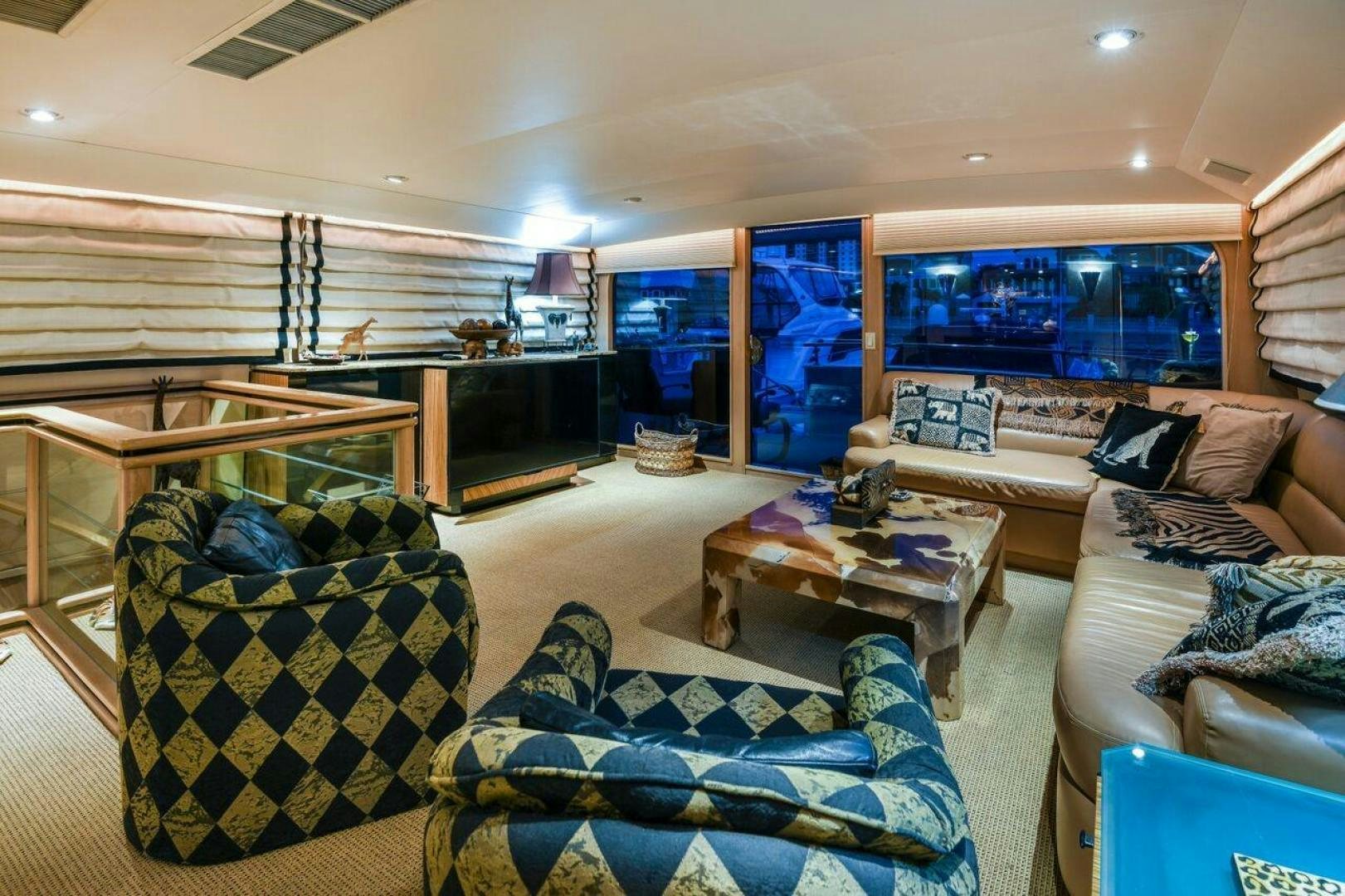 a living room with a couch and a table aboard PRIMETIME III Yacht for Sale
