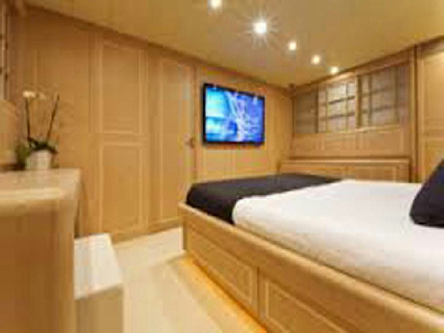 a room with a bed and a window aboard COTE D’AZURE Yacht for Sale
