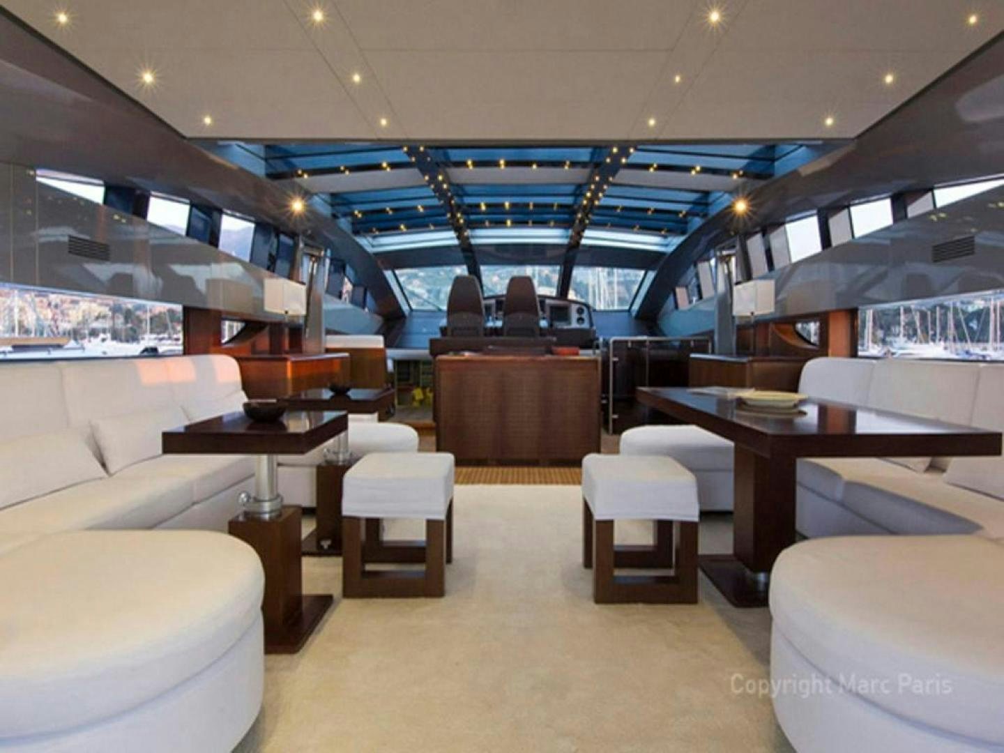 a room with tables and chairs aboard COTE D’AZURE Yacht for Sale