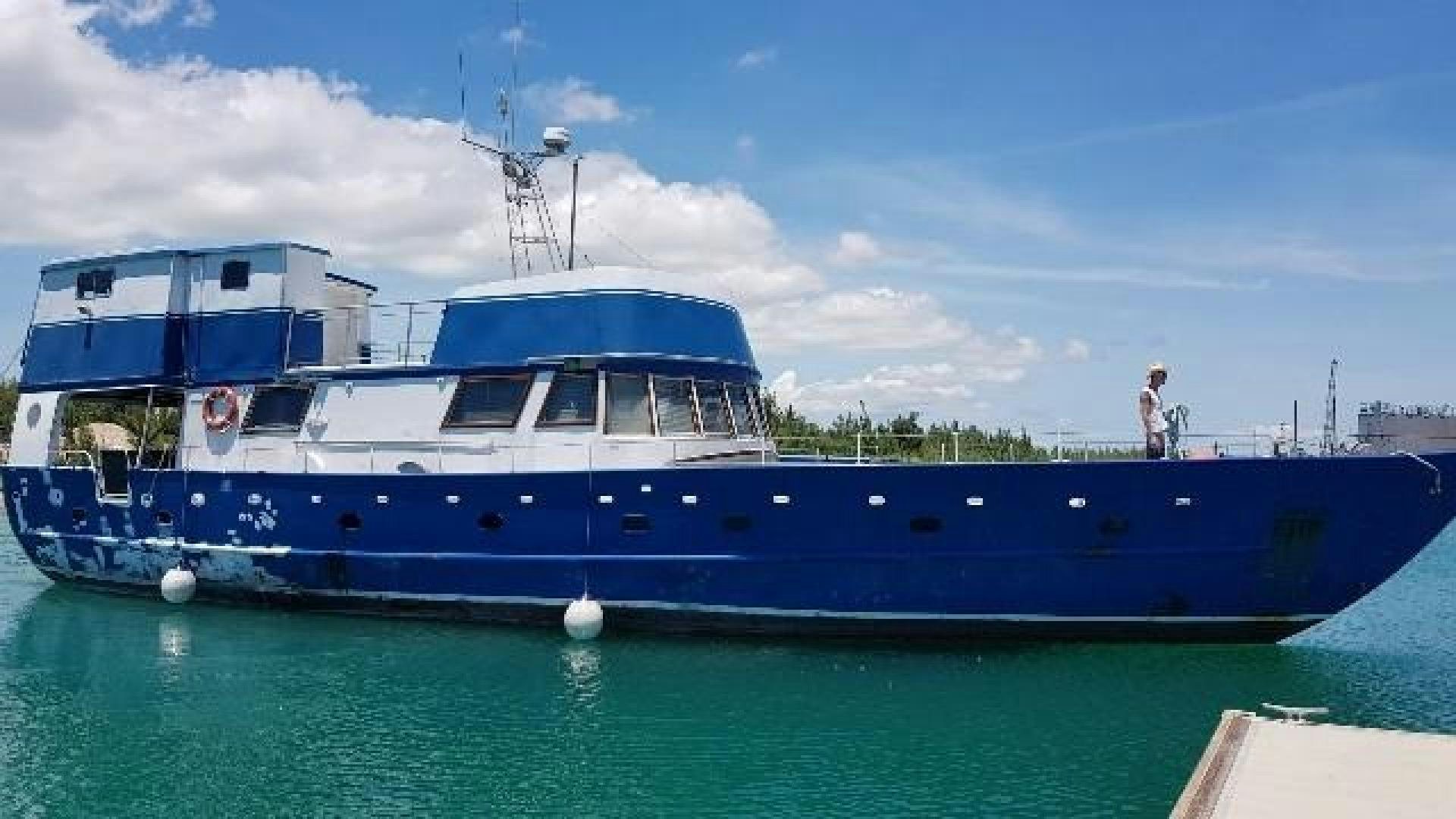 a blue and white boat aboard LAURA MARIE Yacht for Sale