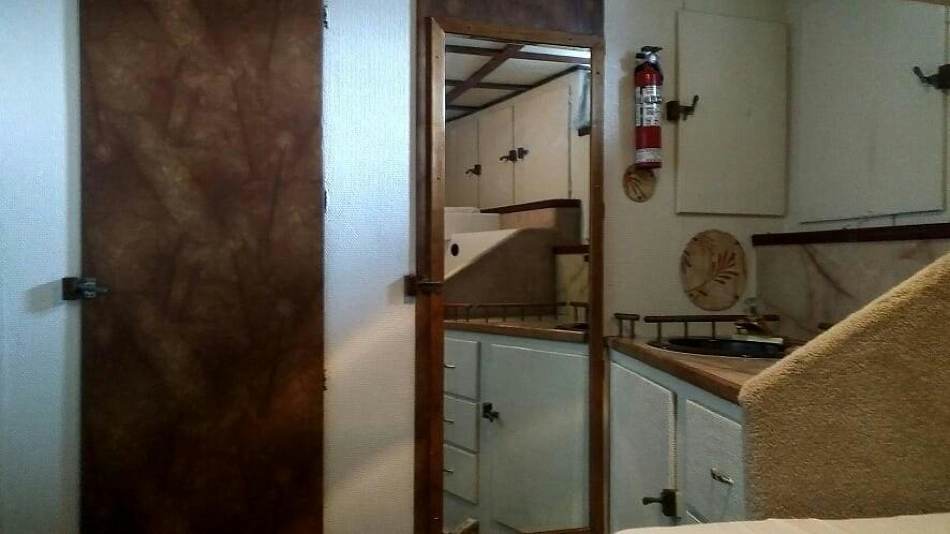a kitchen with a sink and cabinets aboard LAURA MARIE Yacht for Sale
