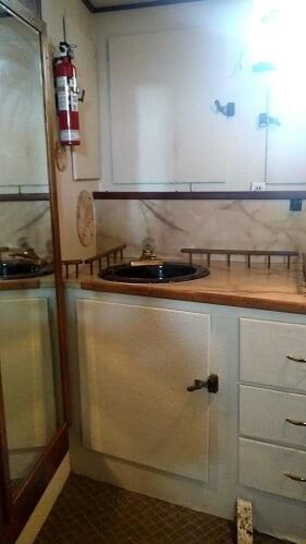 a kitchen with a sink and cabinets aboard LAURA MARIE Yacht for Sale